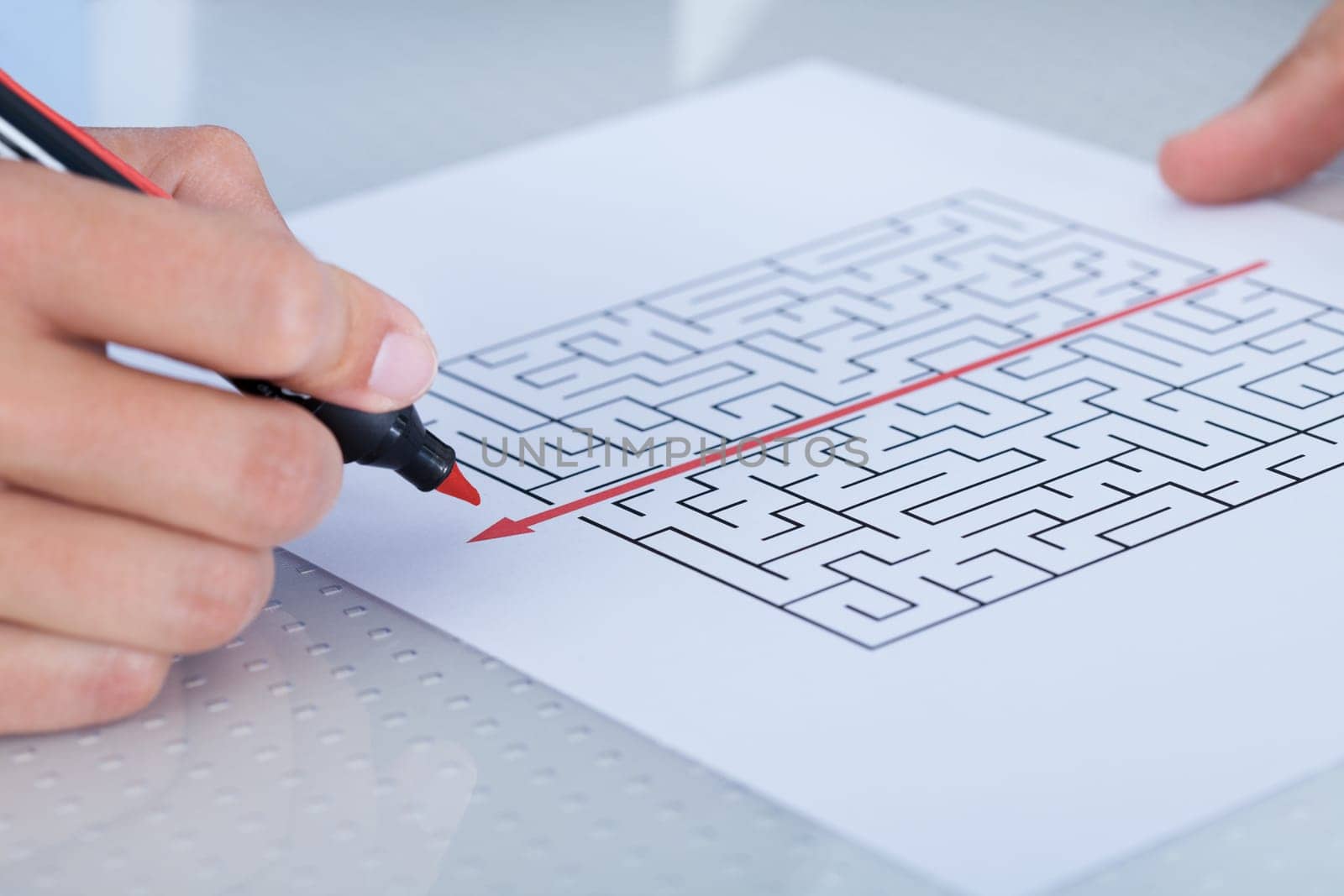 Businessman Solving Maze Puzzle With Red Pen