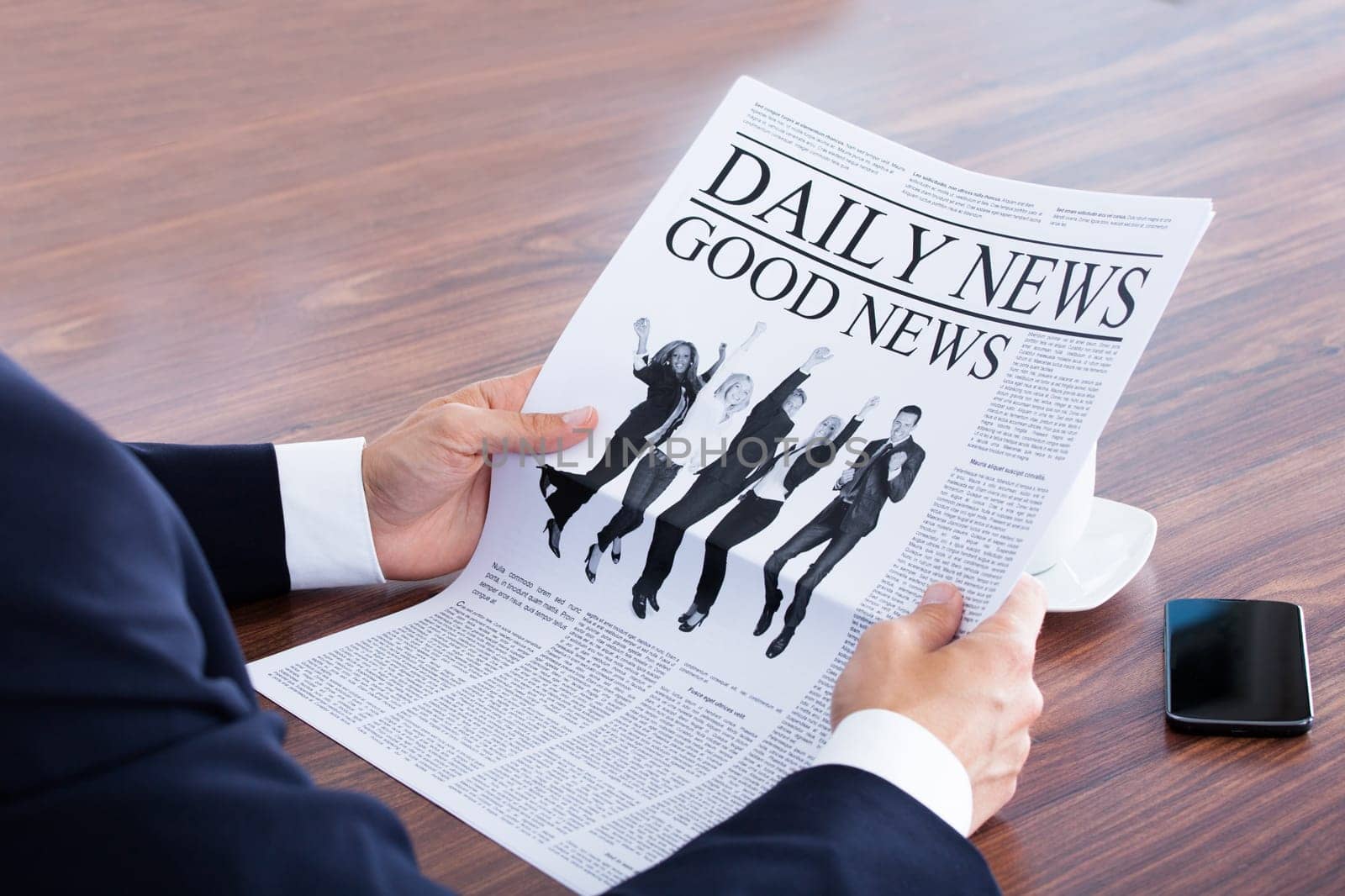 Close-up Of Businessman Reading News On Newspaper