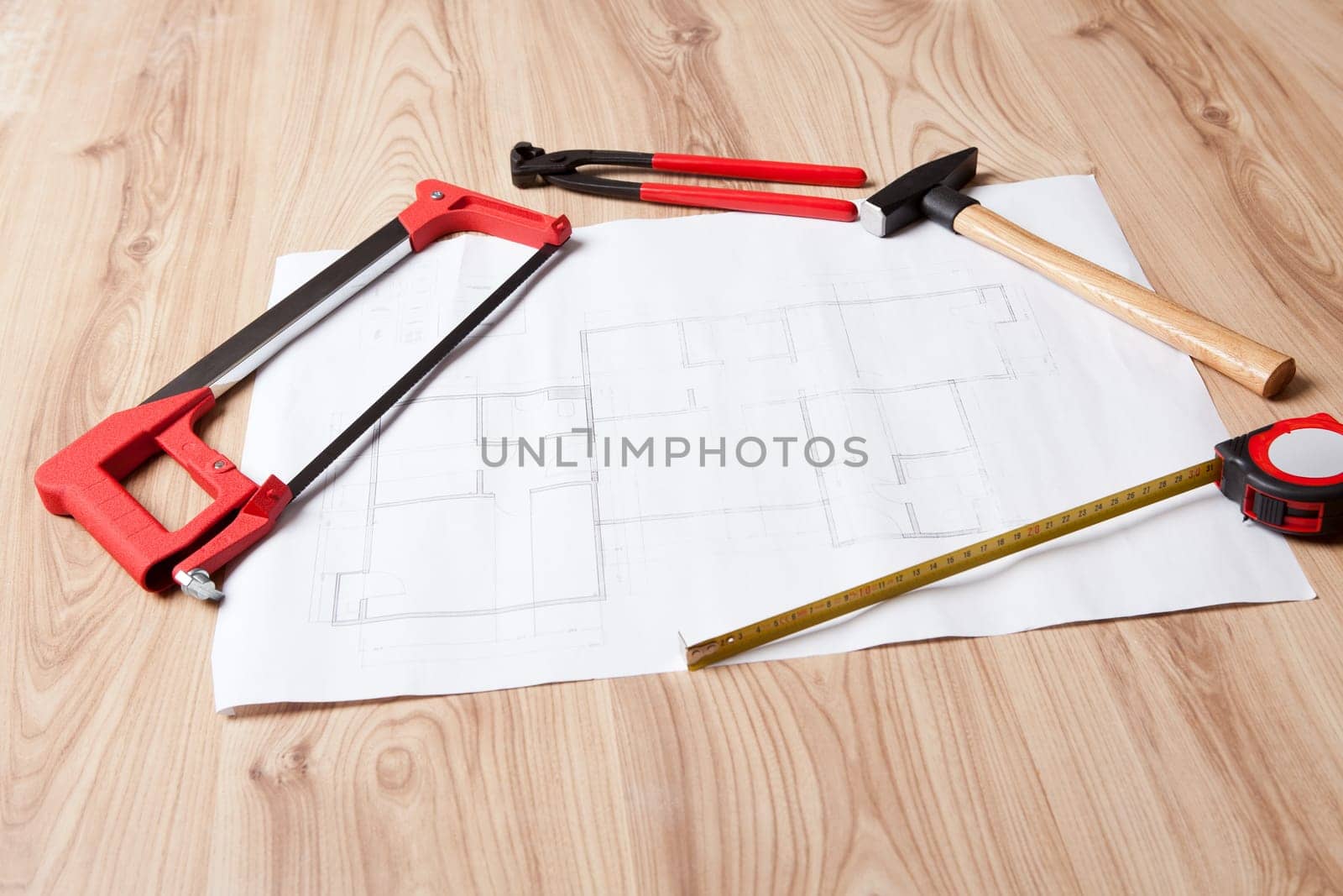 Photo of carpenter tools and building plan