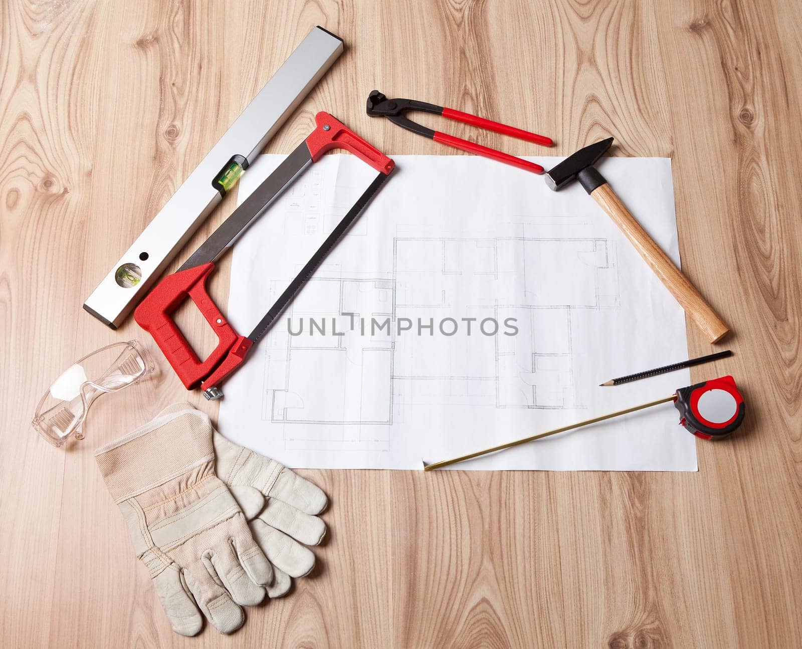 Photo of carpenter tools and building plan