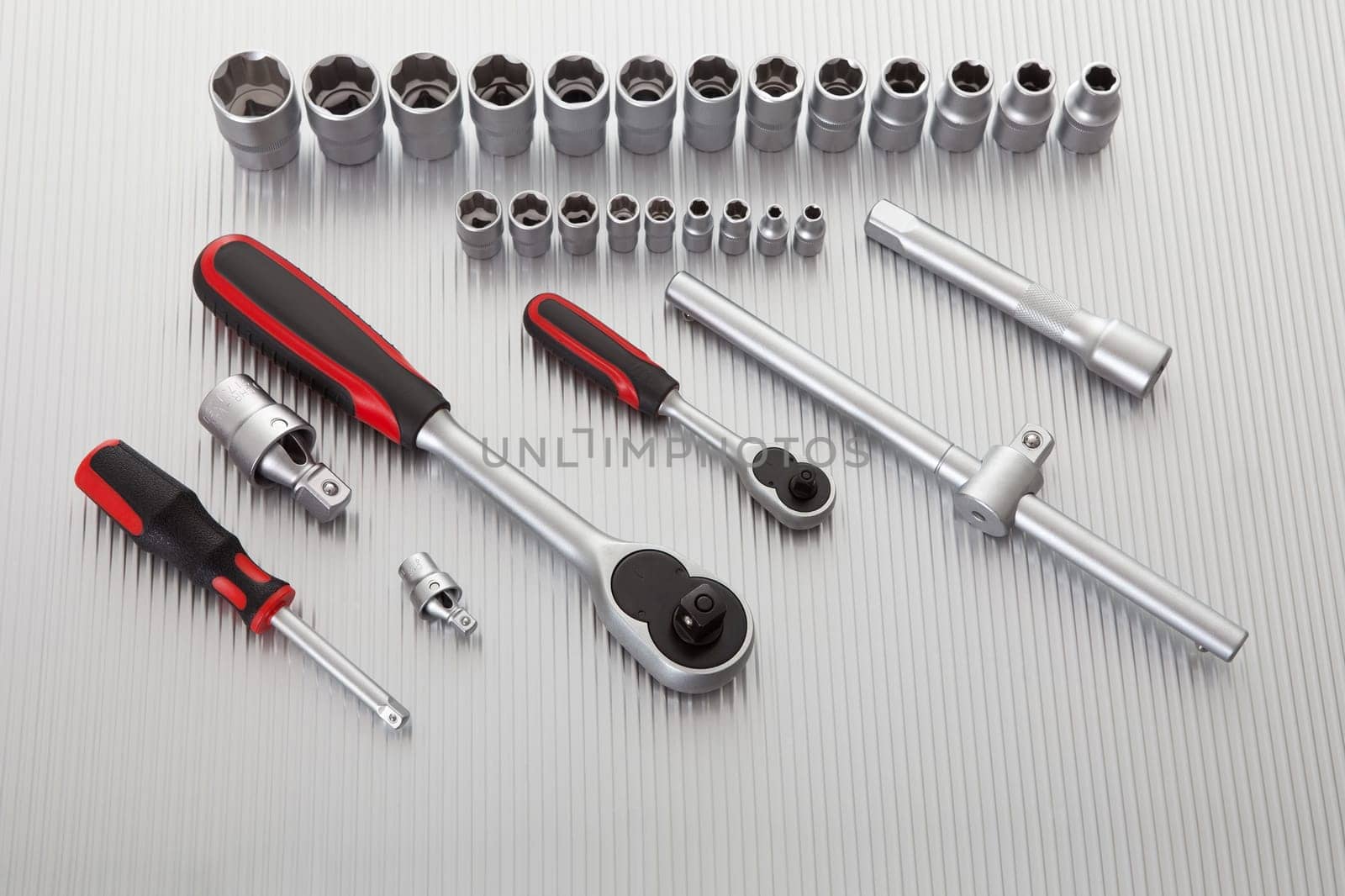 Metallic wrench tool set on metal background