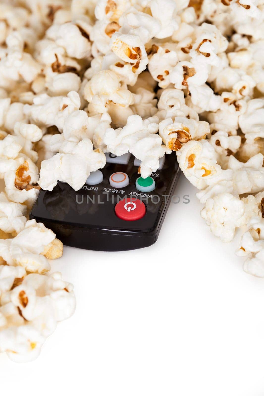 Close-up Of Remote Control And Popcorn Over White Background