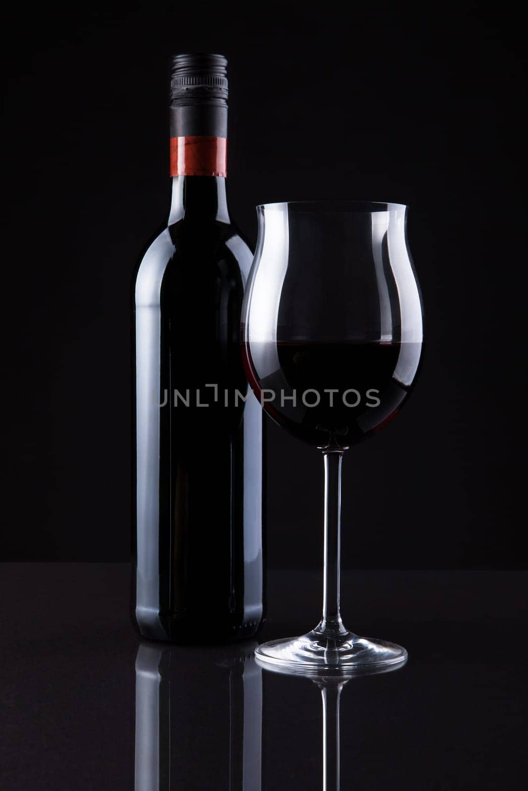 Bottle Of Wine And Glass Isolated On Black Background