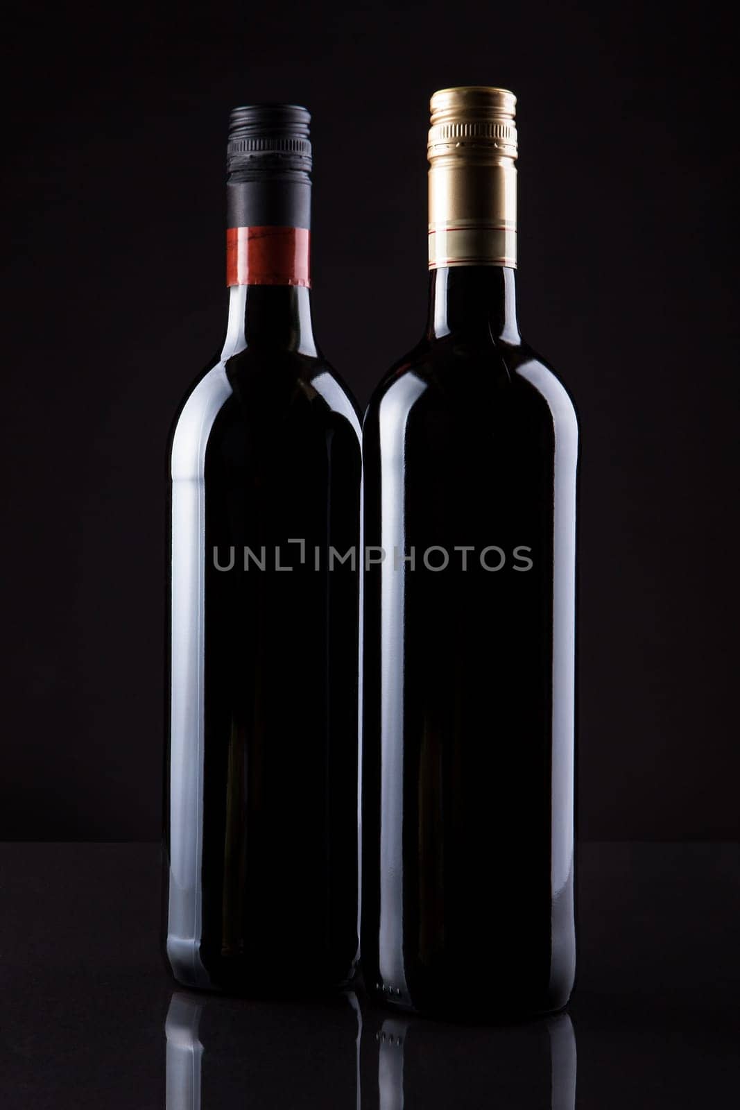Two Bottles Of Wine Isolated On Black Background