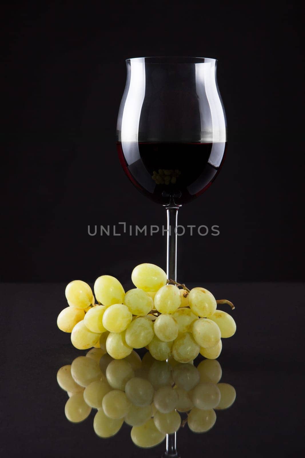 Still Life Of Wine And Grapes On Black Background