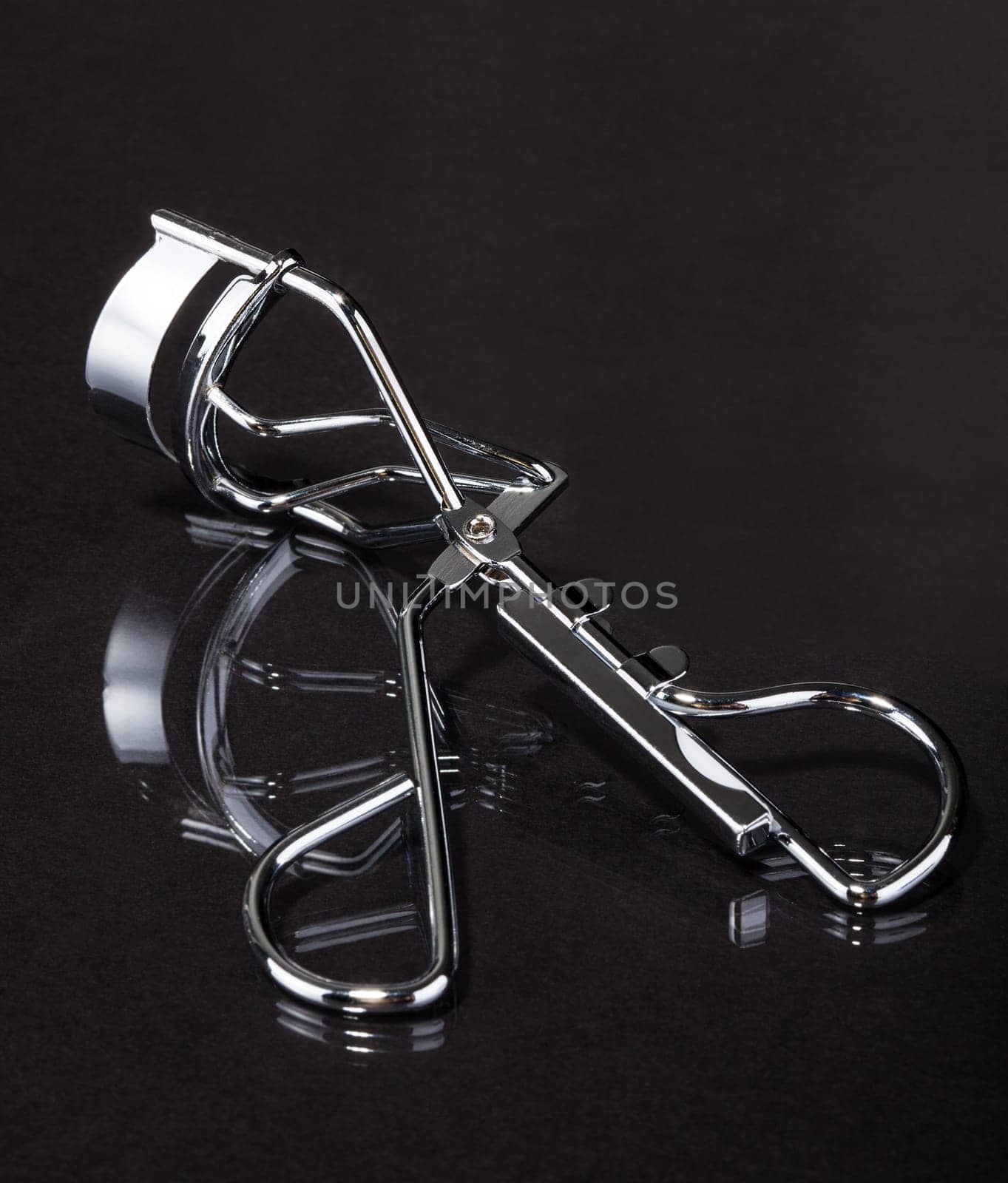 Close-up Of Eyelash Curler On Gray Background