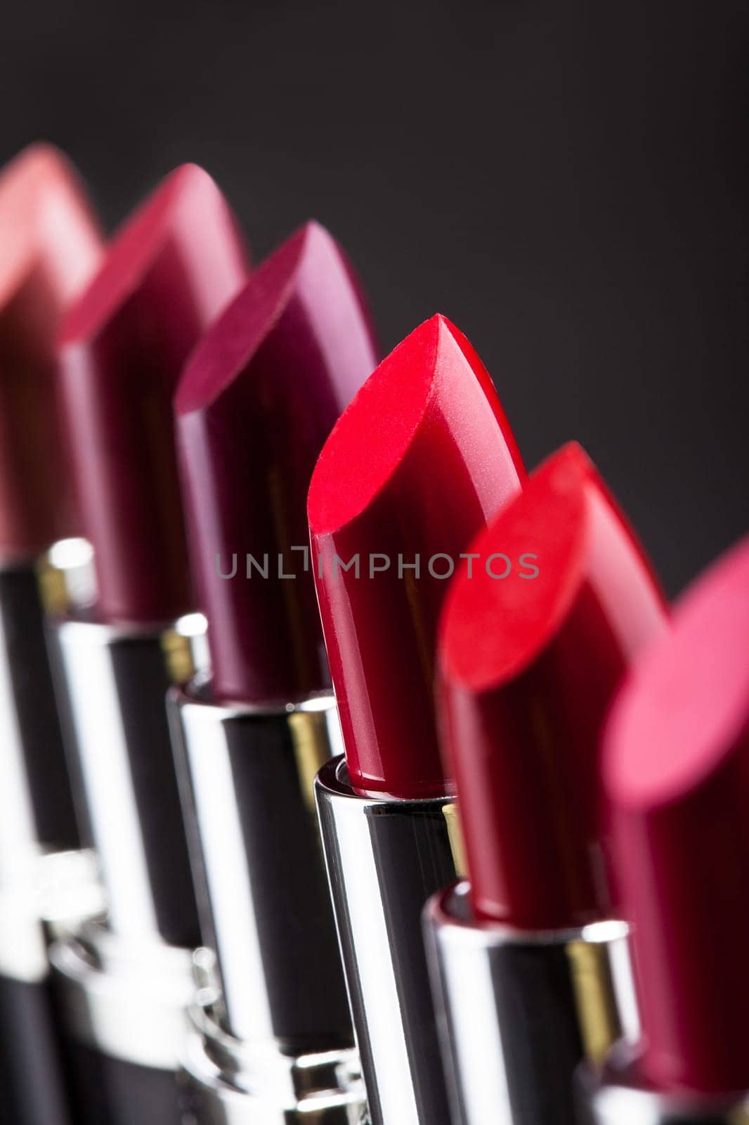 Lipsticks In A Row Isolated Over Gray Background