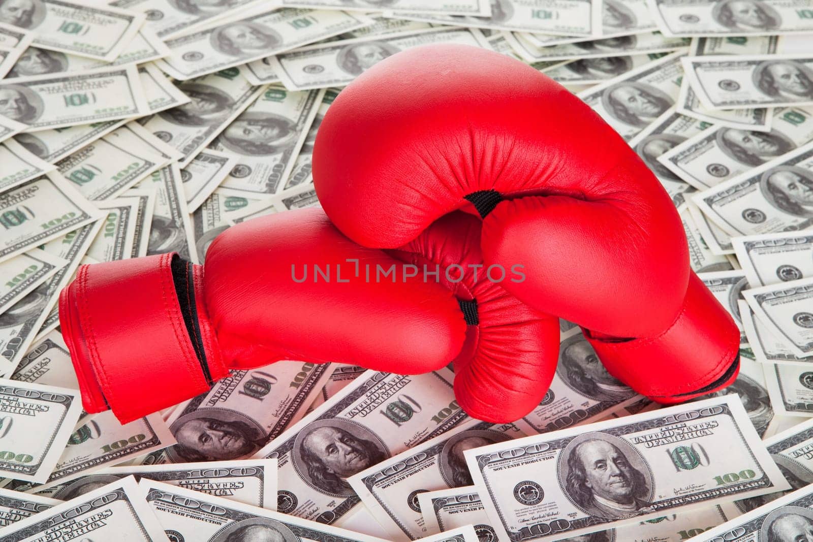 Boxing gloves on top of 100 dollars bills