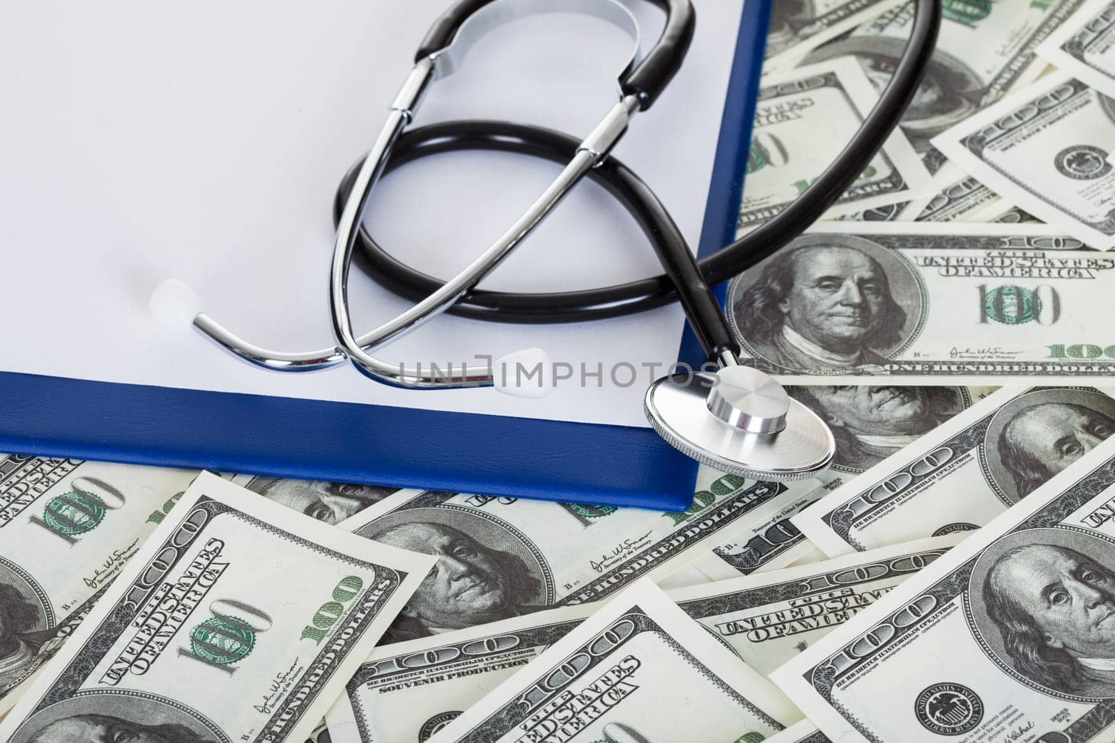 Photos of stethoscope and american dollar notes