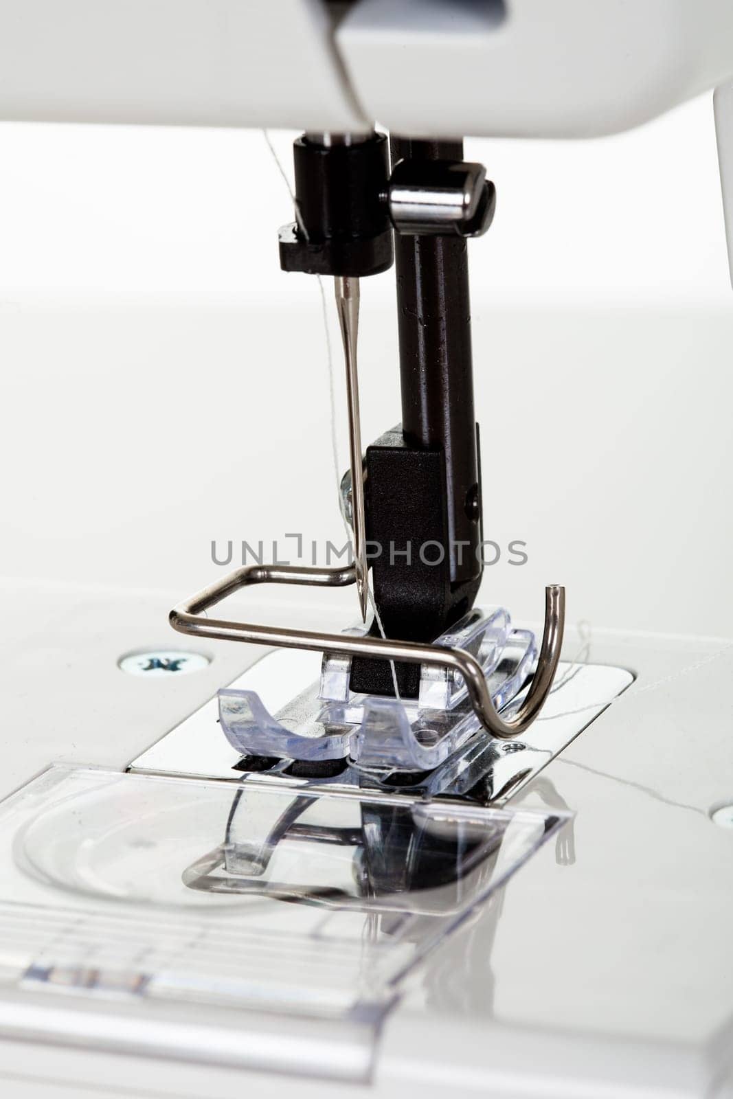 Close-up of sewing machine. Isolated on white