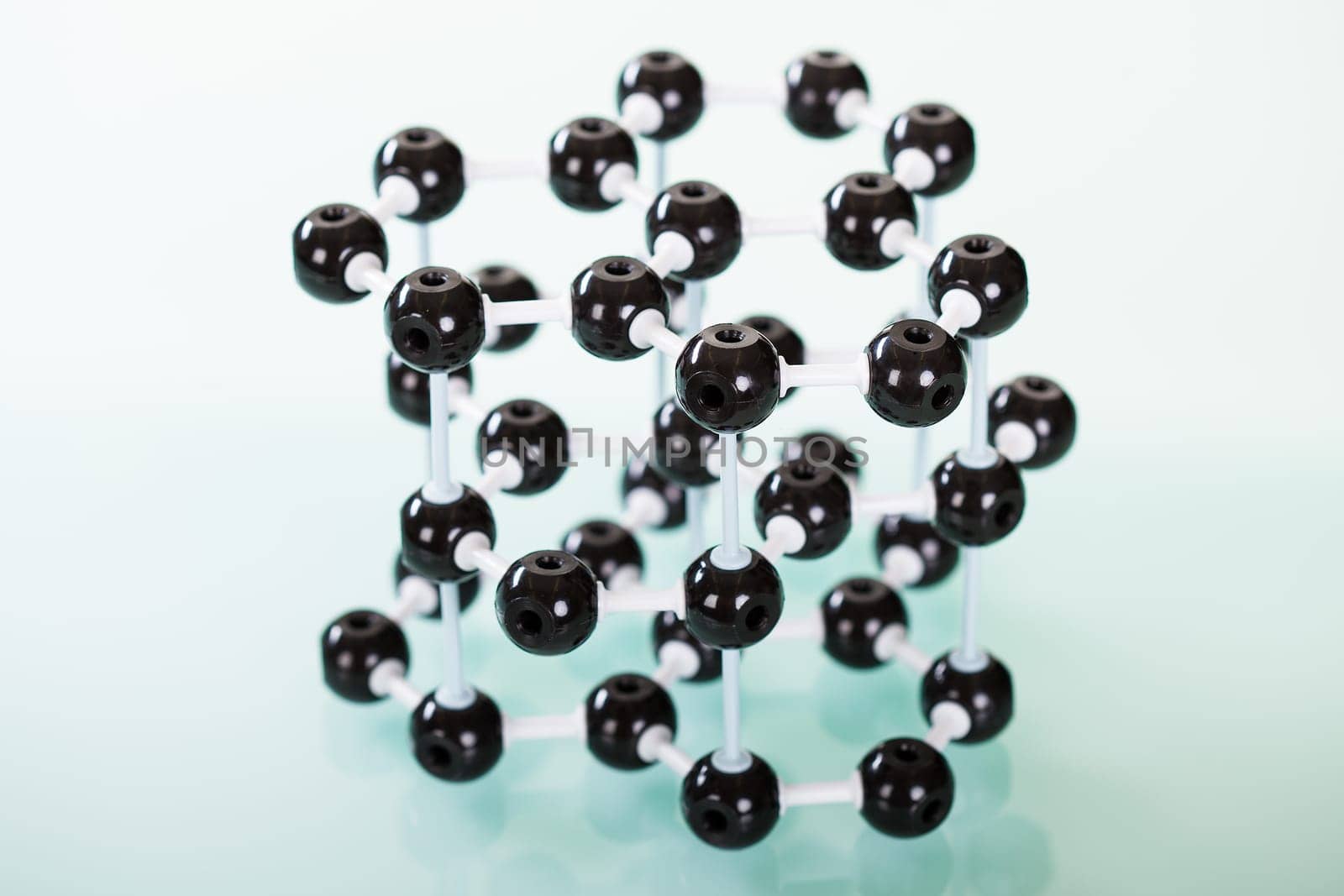 Model of graphite  molecular structure on green reflective background