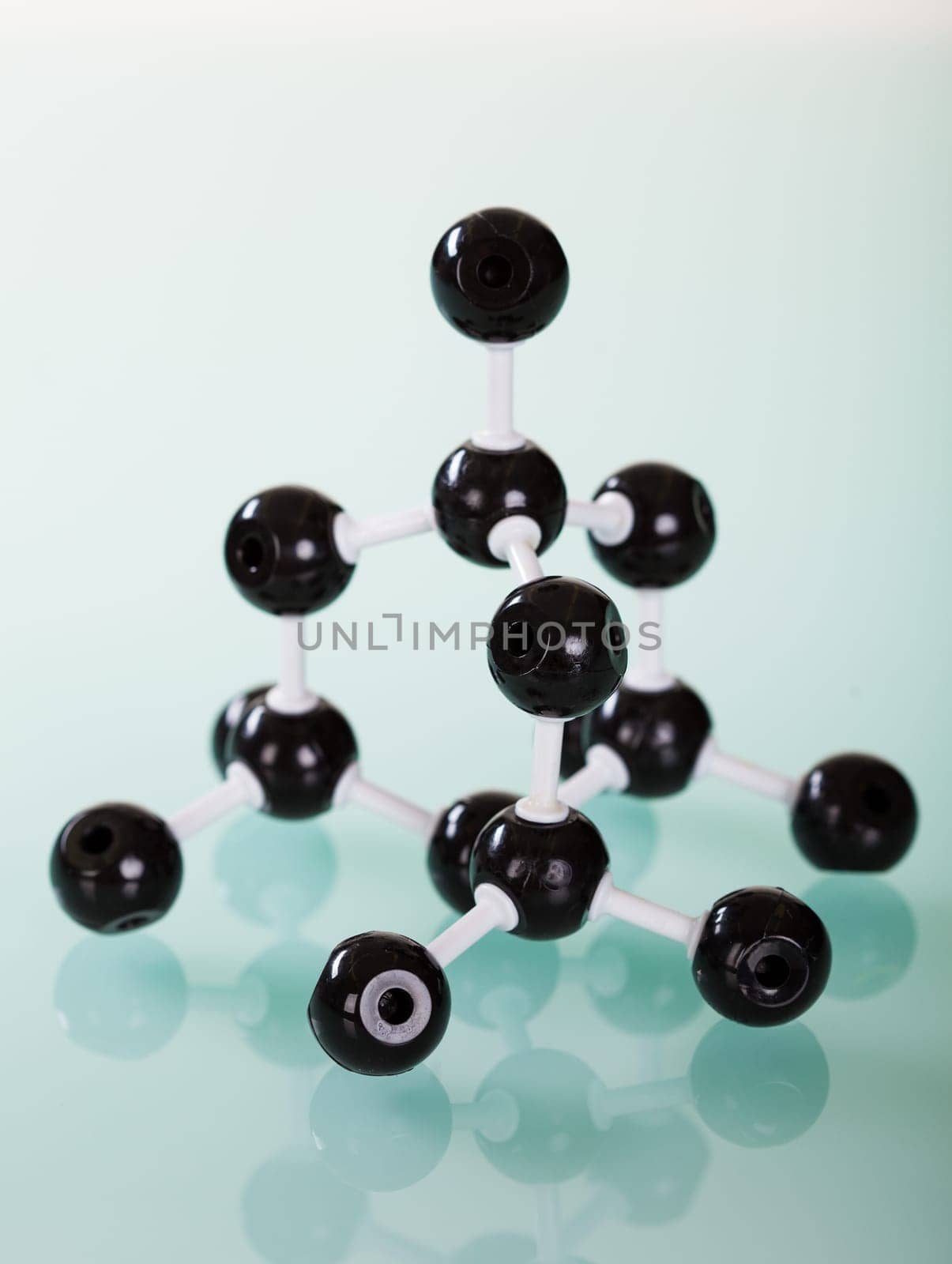 Model of graphite  molecular structure on green reflective background