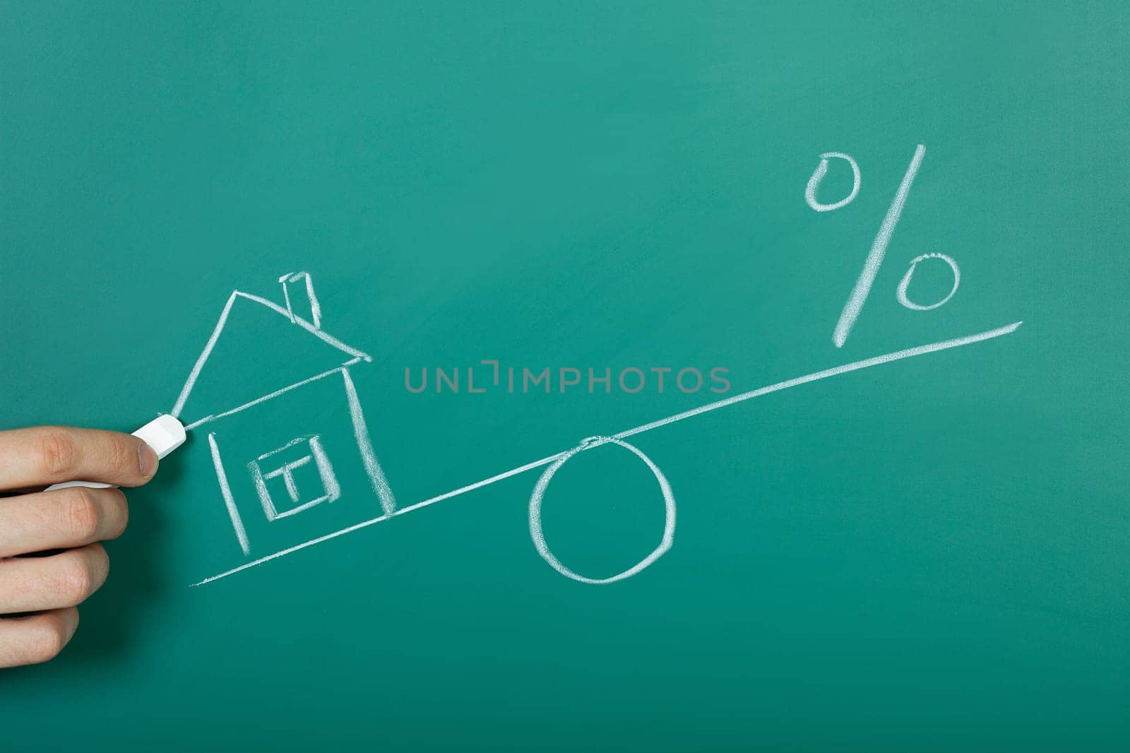 Drawing a mortgage illustration on a chalkboard