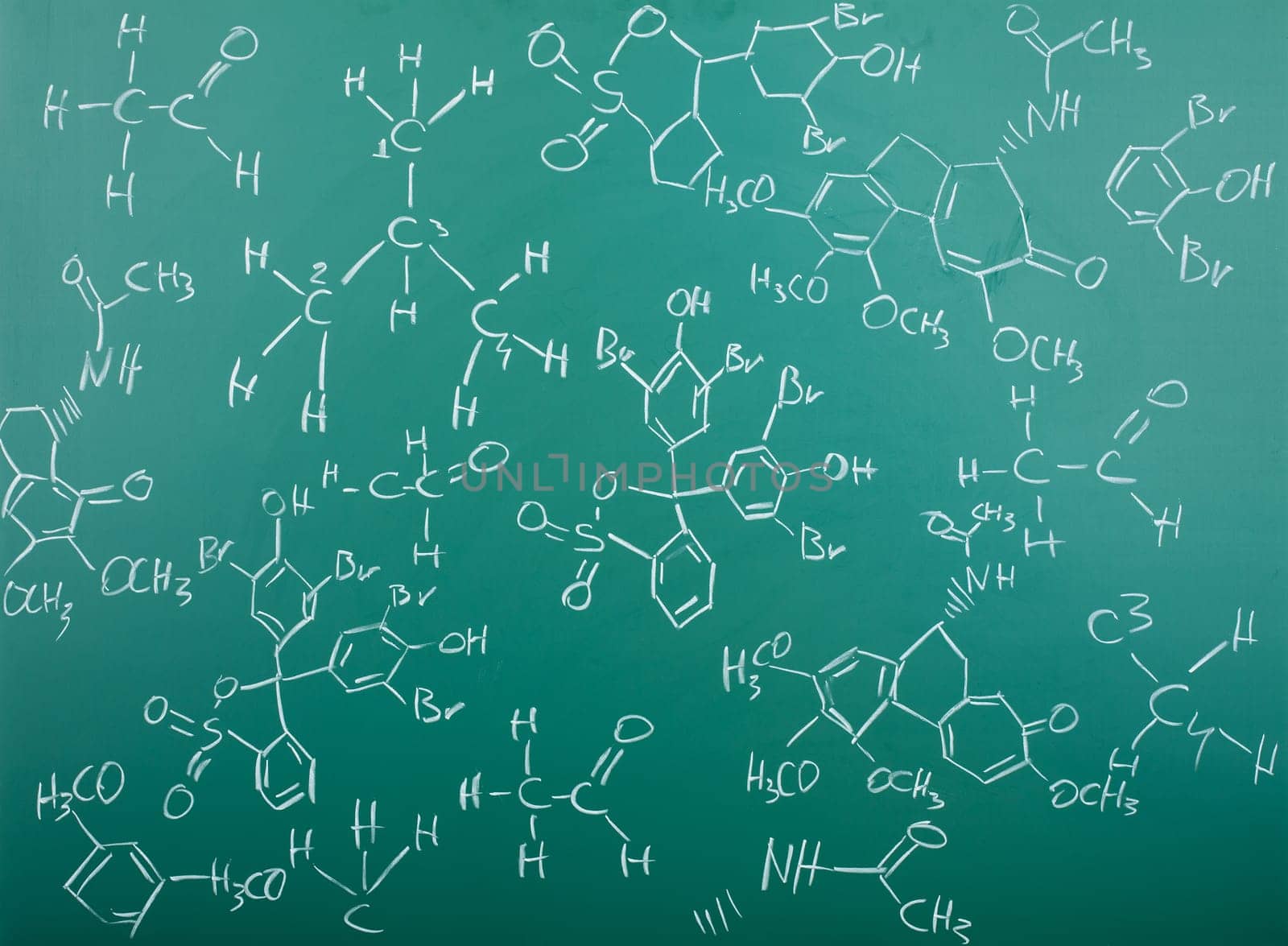 Organic chemical formulas on a green chalkboard