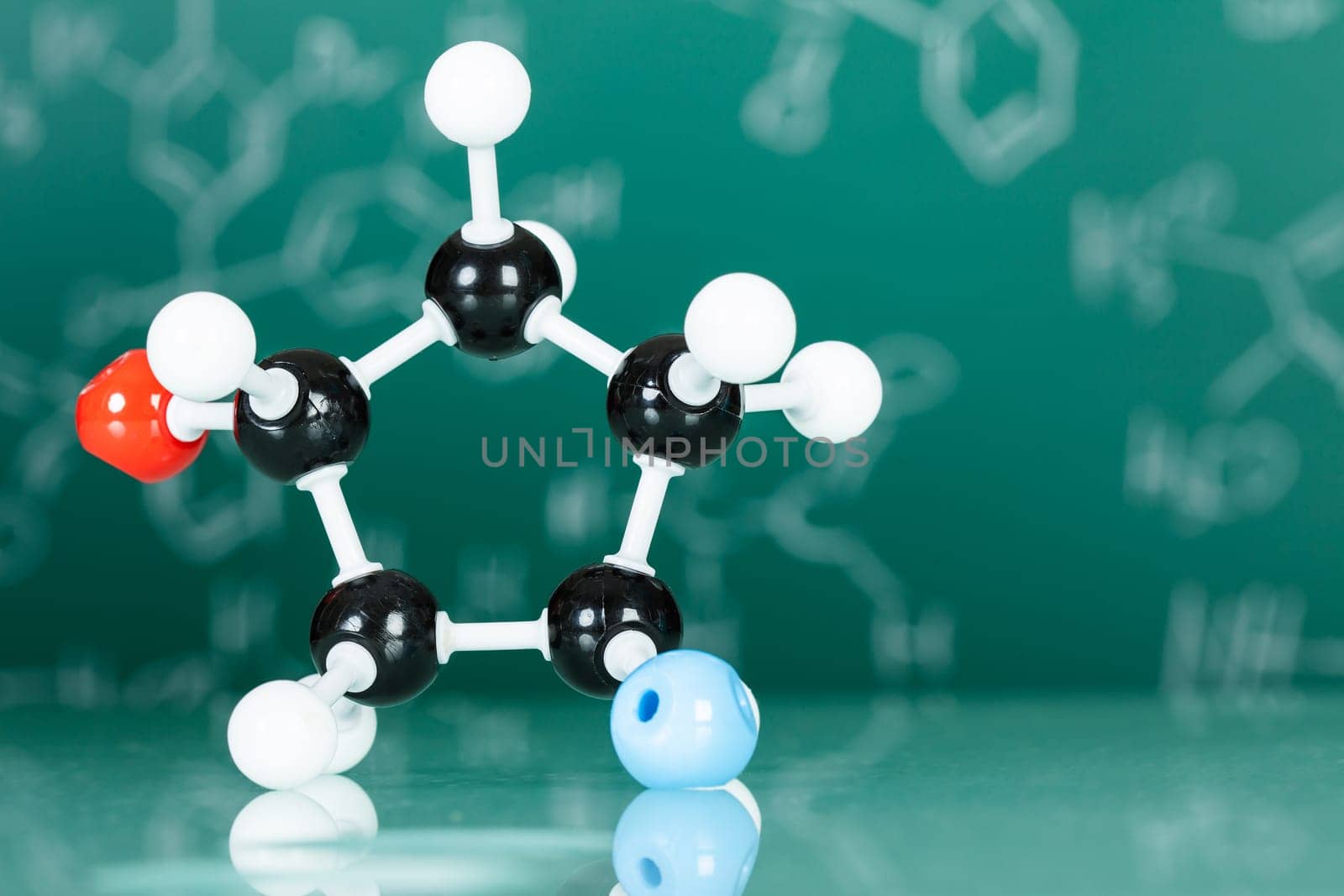 Model of molecular structure on green reflective background