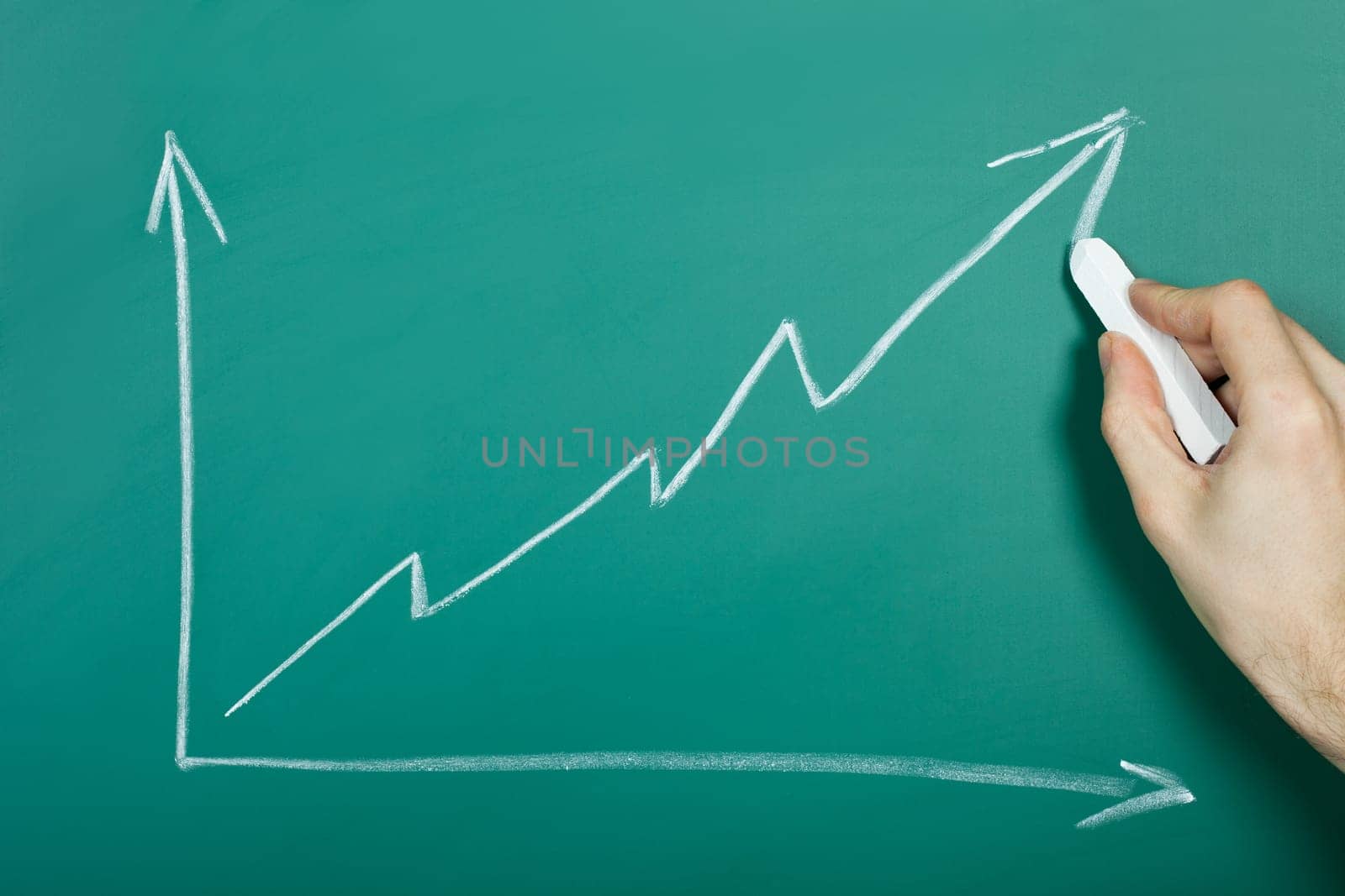 Hand drawing growth chart on green chalkboard