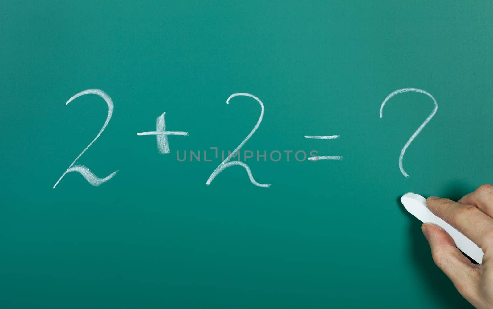 Hand writing 2 plus 2 on blackboard