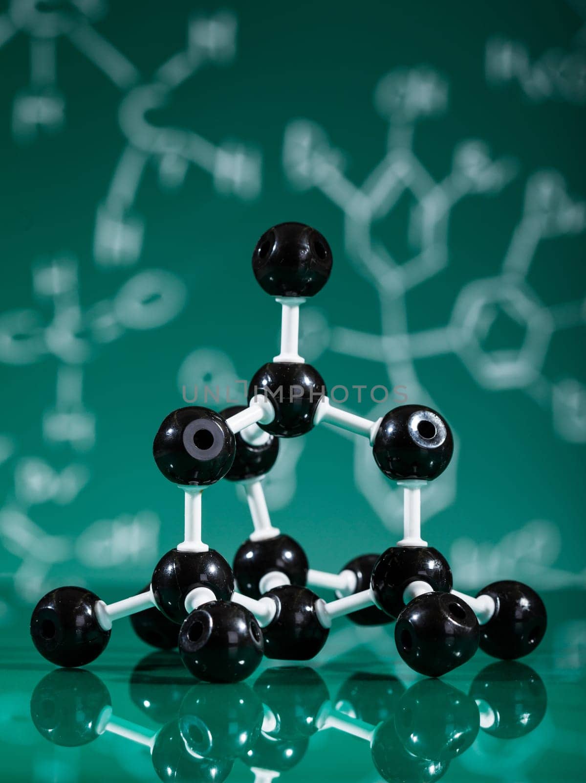 Model of graphite  molecular structure on green reflective background