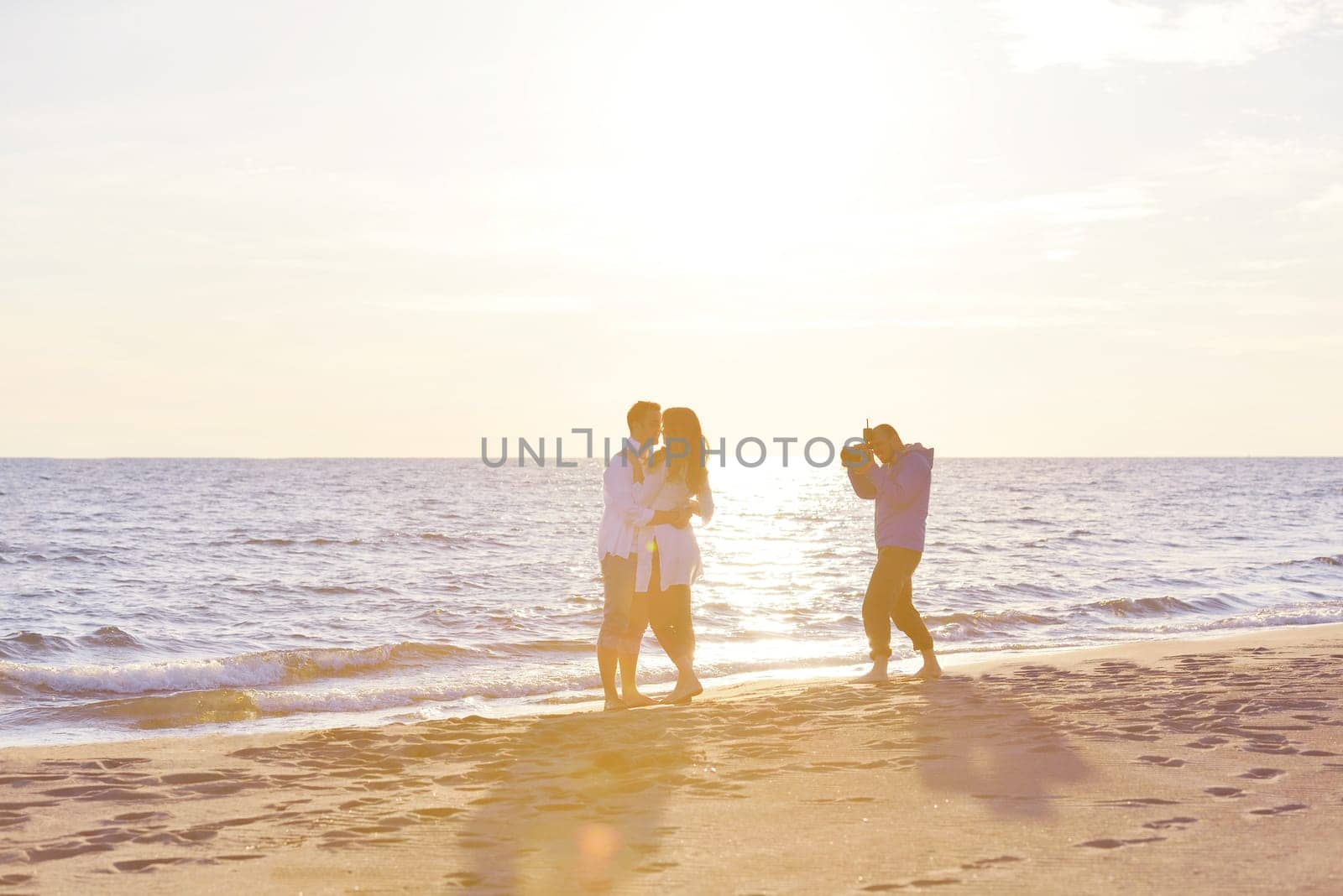 happy young romantic couple in love have fun on beautiful beach at beautiful summer day