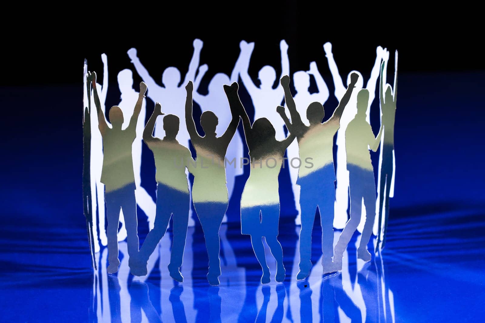 Silhouettes of exited people standing in circle