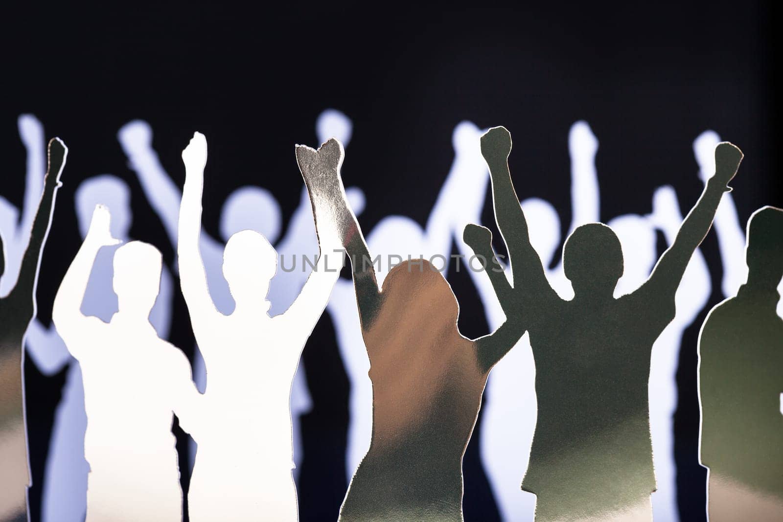 Silhouettes of exited people standing in circle