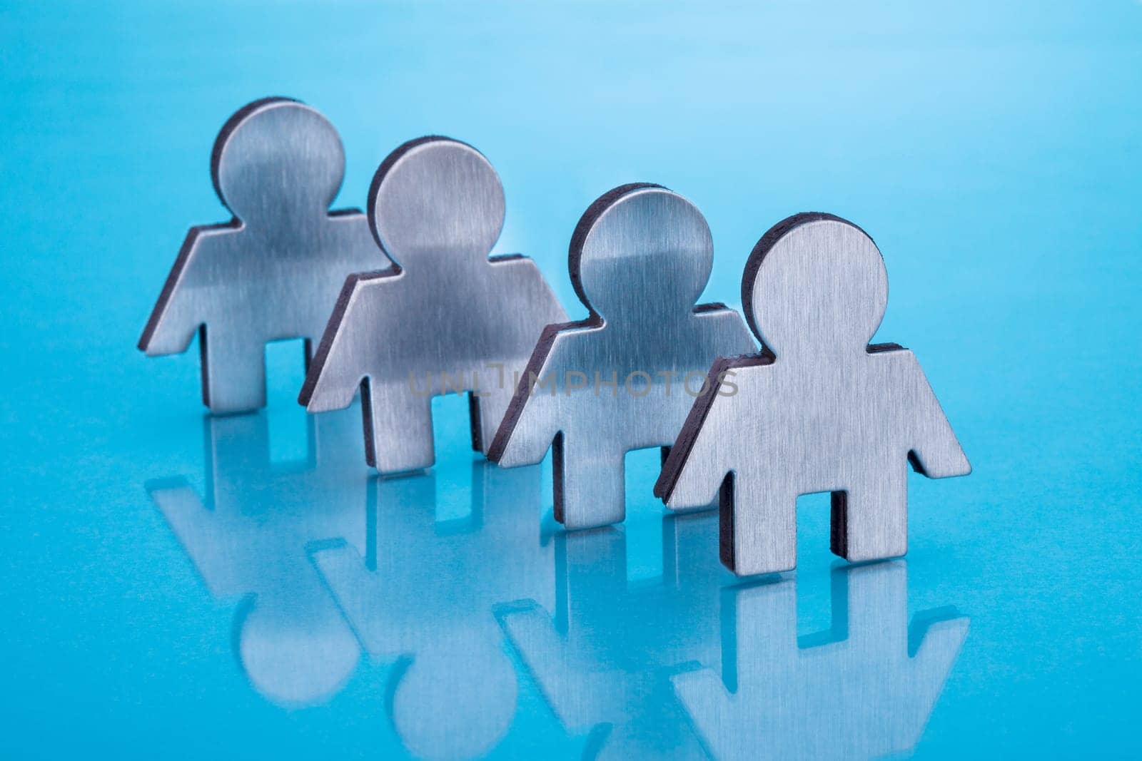 Cut Out Human Figure Of Metal Over Blue Background