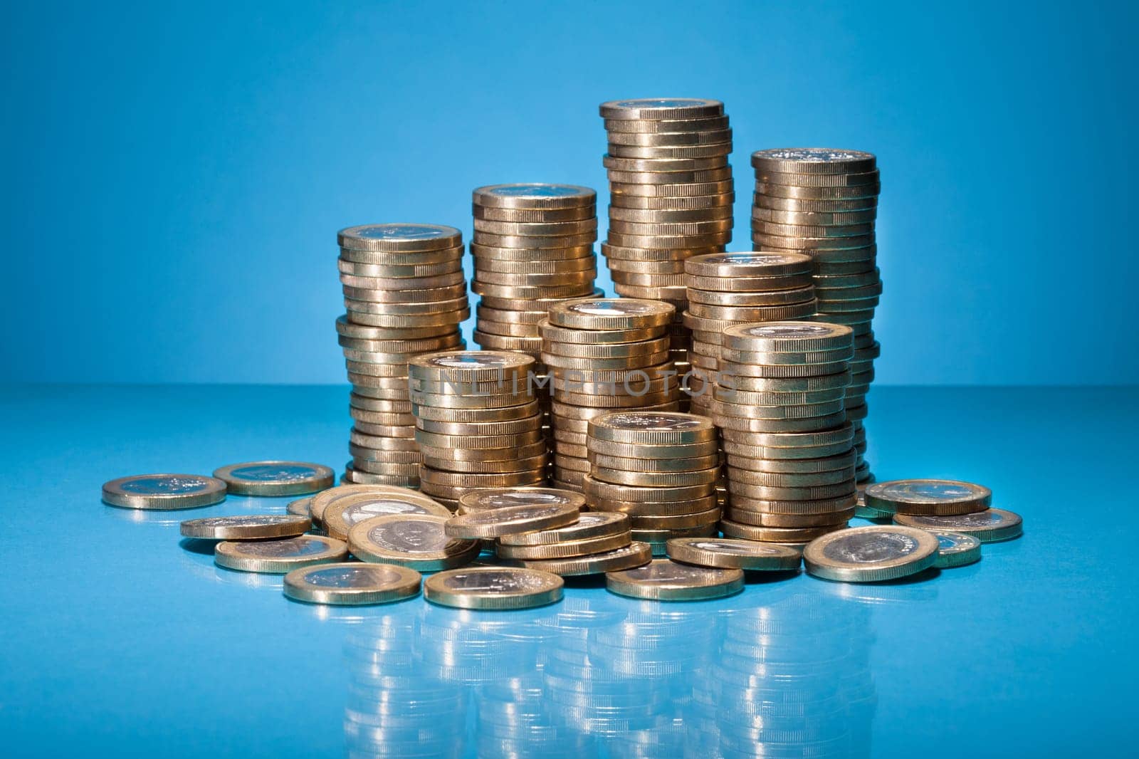Stack Of Golden Coin Over Blue Background