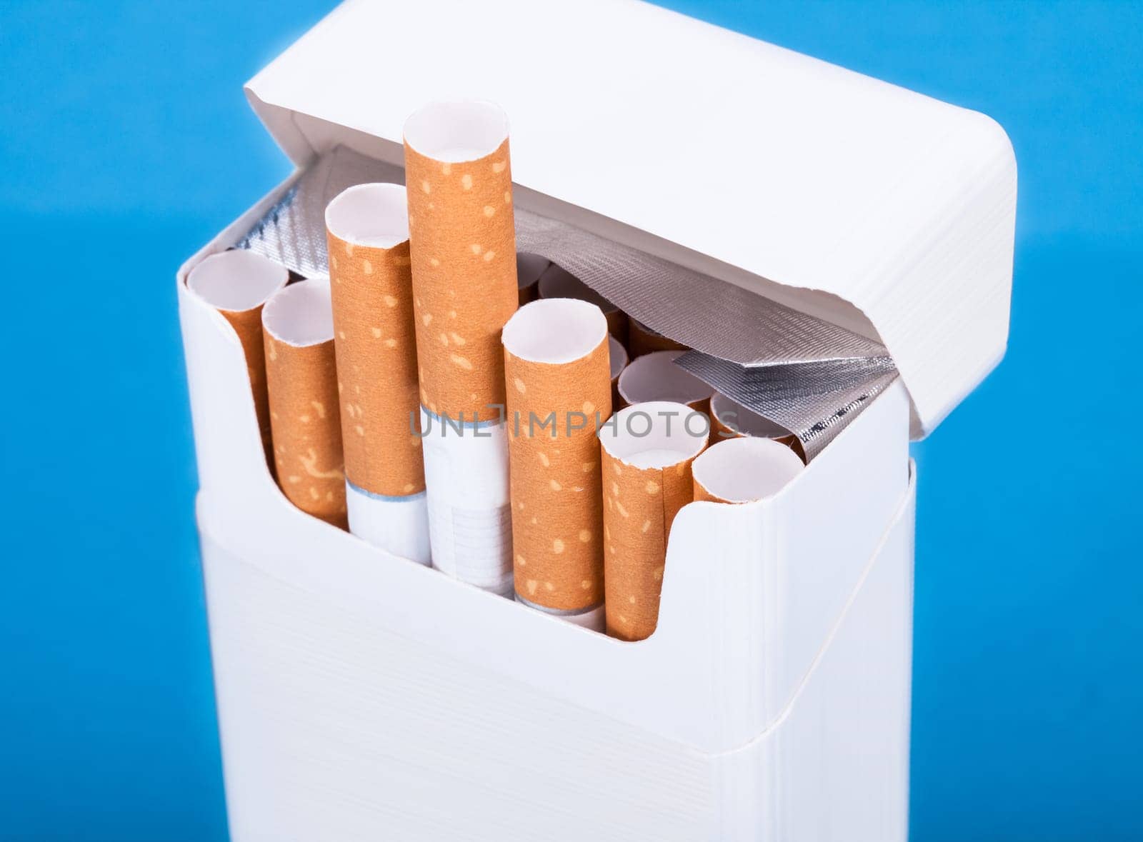 Photo Of Cigarettes In Pack Over Blue Background