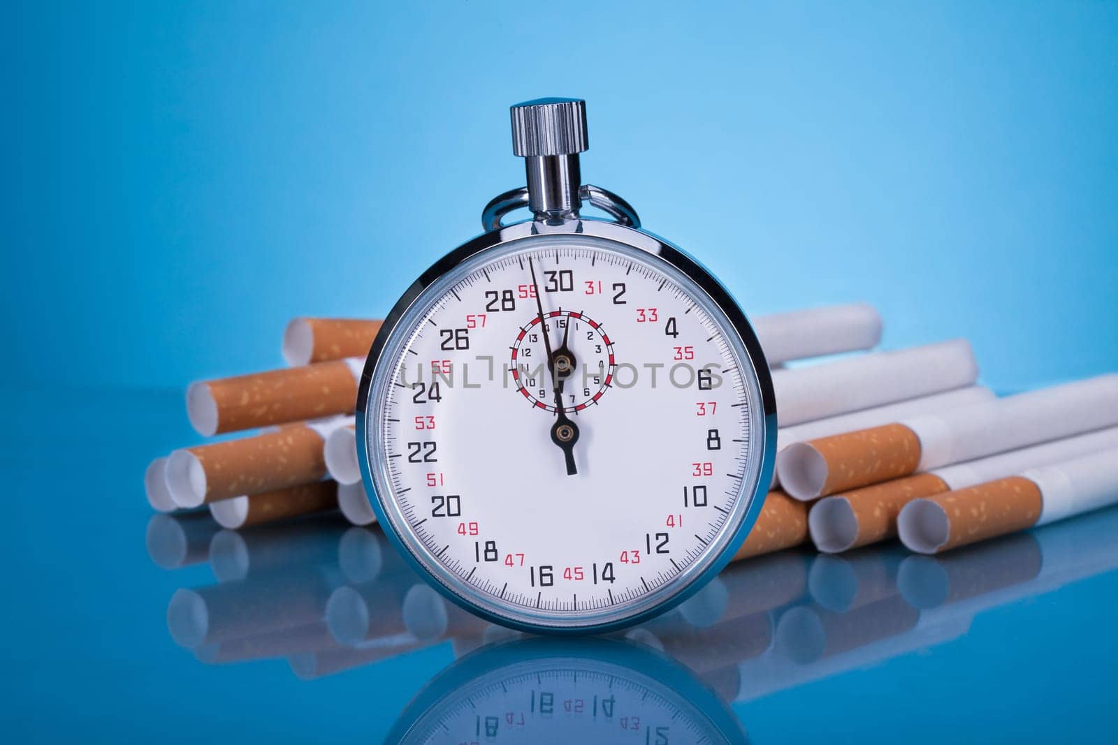 Photo Of Stopwatch And Cigarettes On Gray Background
