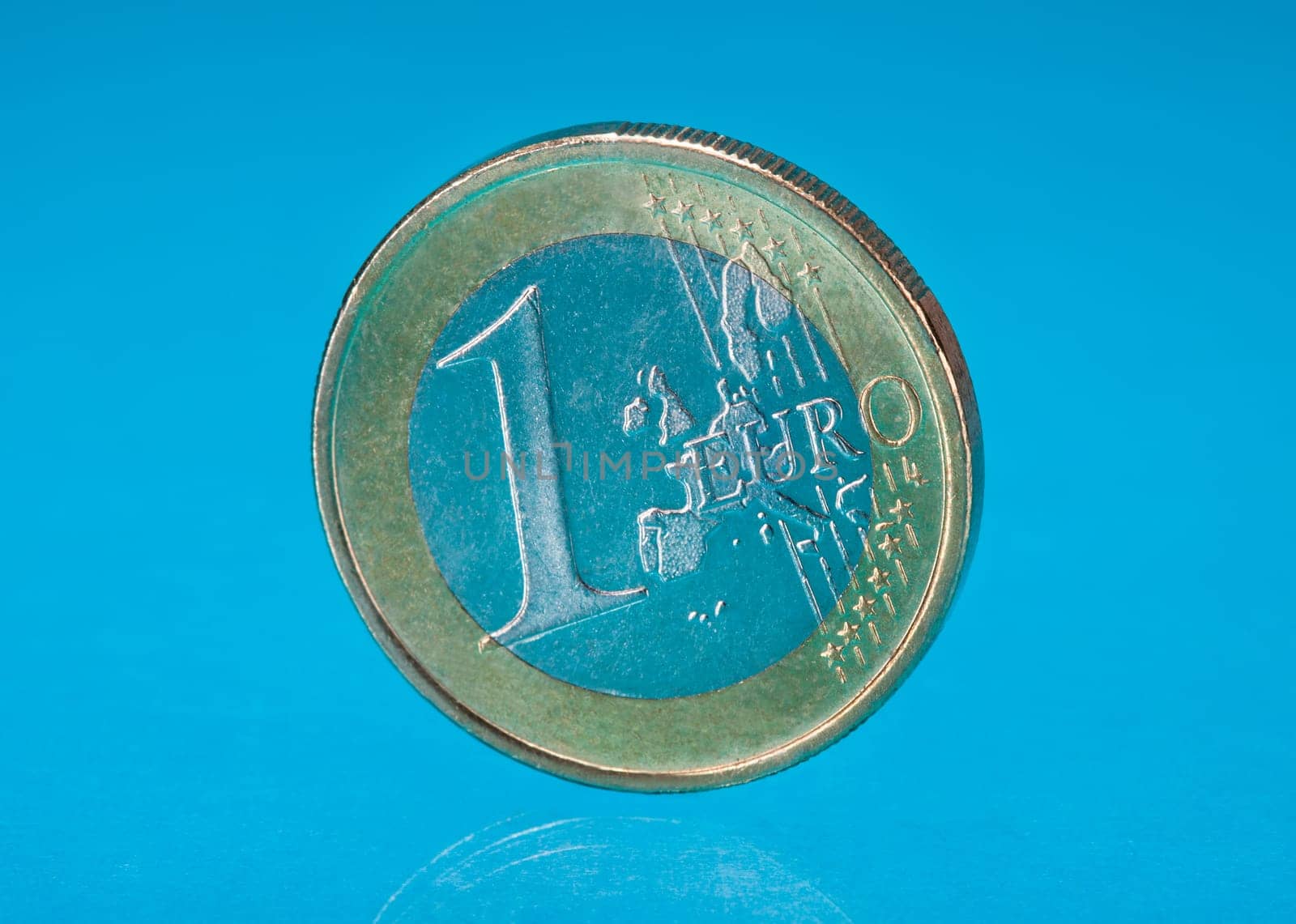 Photo Of One Euro Coin Over Blue Background