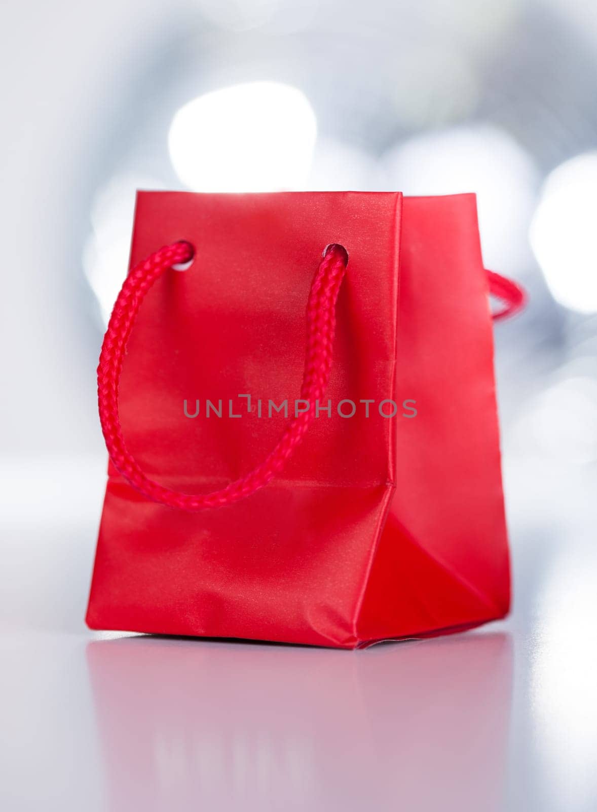 Close-up Of A Red Gift Bag With White Ribbon