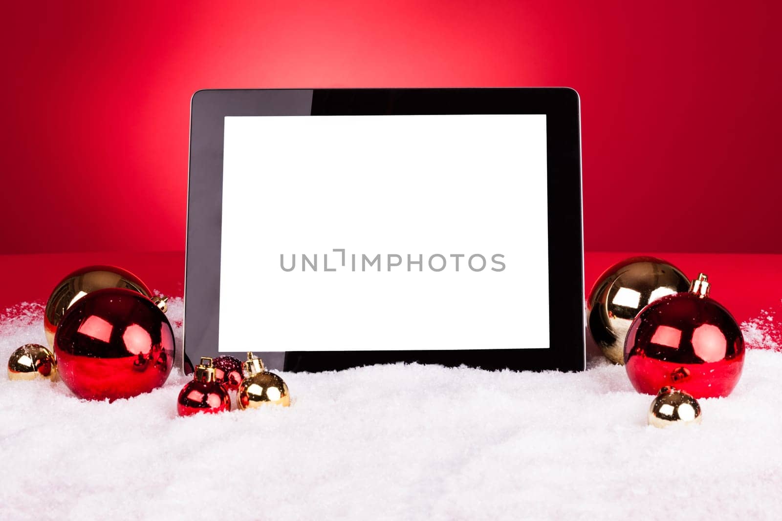Blank Digital Tablet With Christmas Baubles On Red Background
