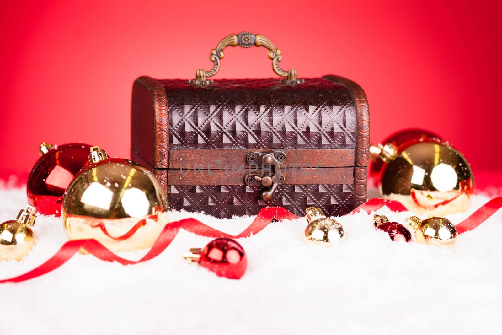 Decorative Christmas Bauble With Treasure Box On Red Background