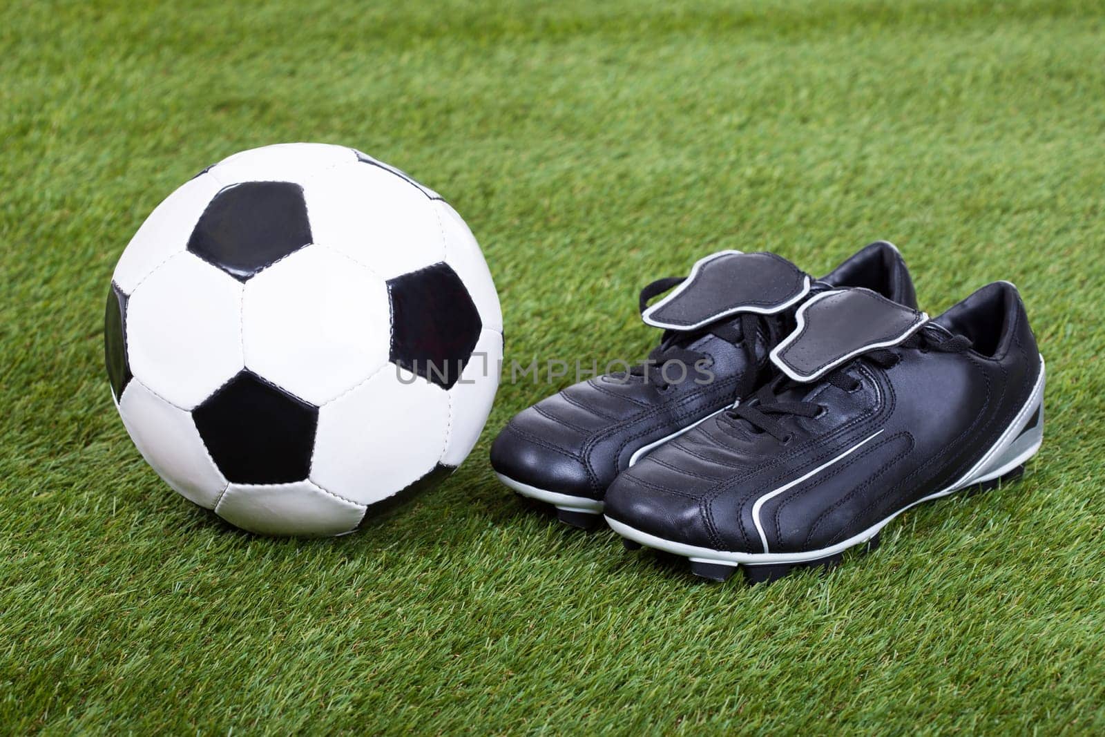 Close-up Of Football And Cleats On The Field