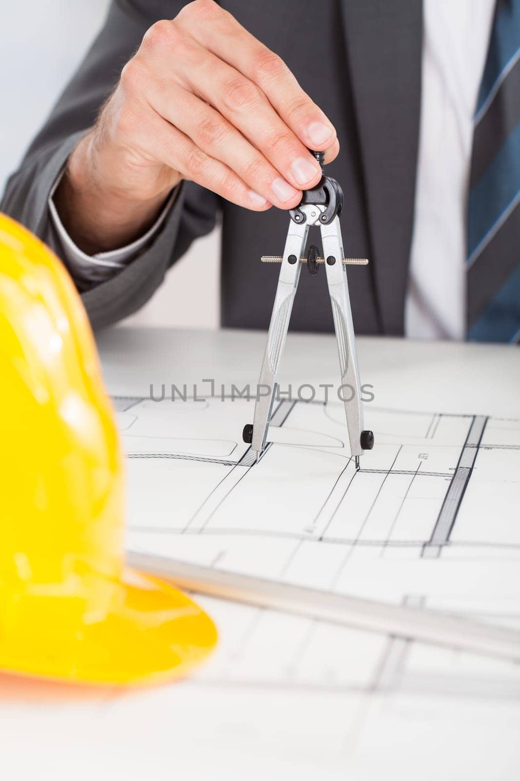 Close-up Of Person's Hand Drawing Plan On Blue Print