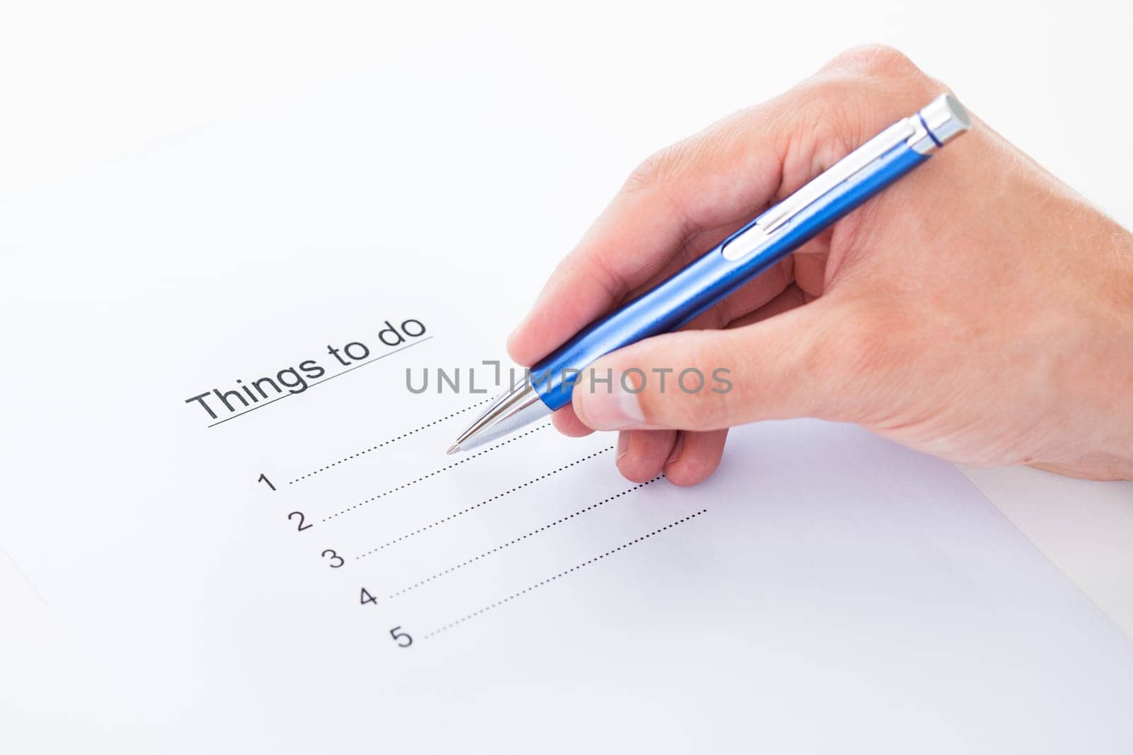 Closeup on hand filling things to do list