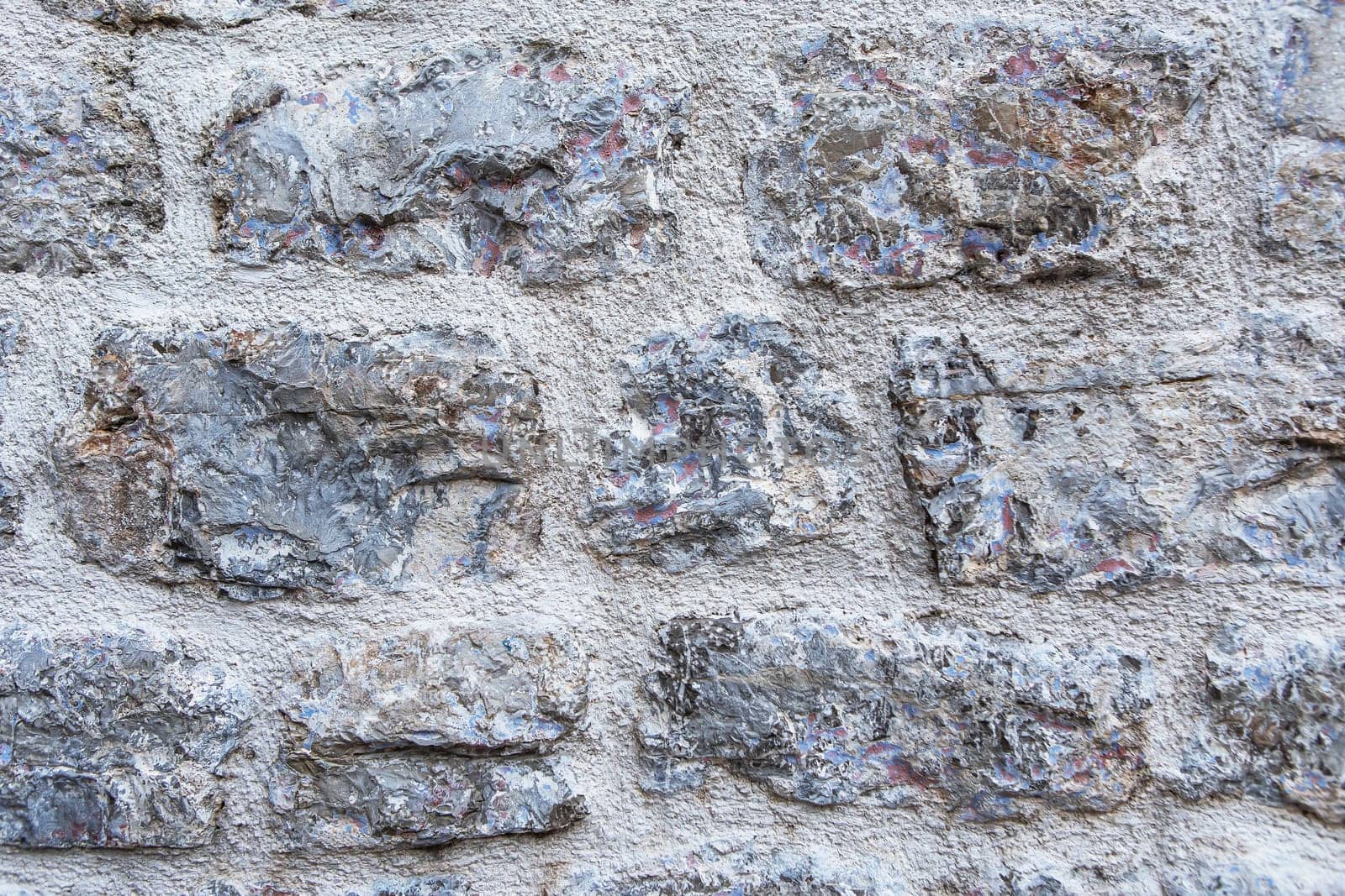 Close-up of a textured stone wall. An old house