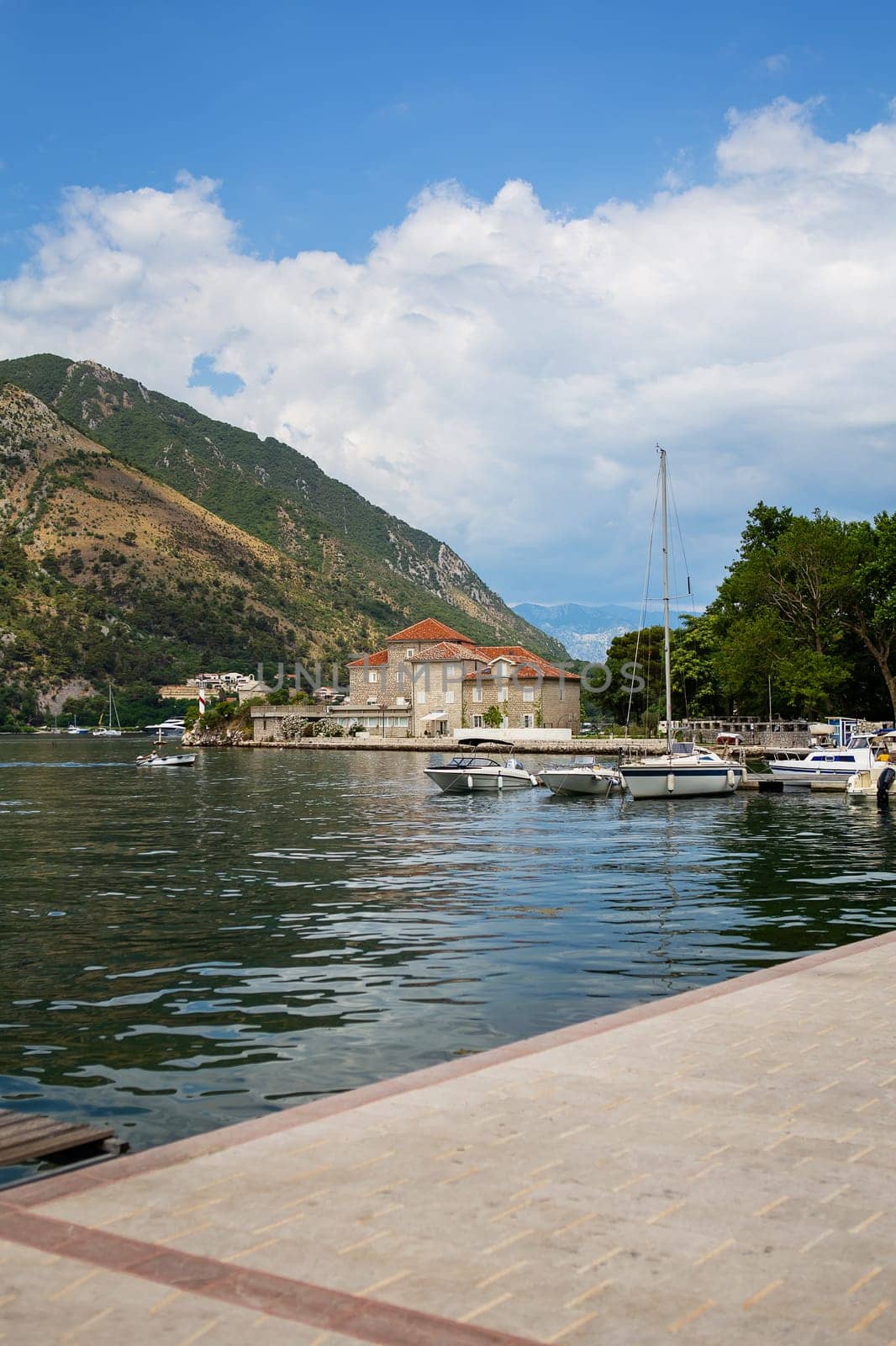 Very beautiful embankment of the Bay of Kotor, Montenegro. A beautiful and cozy city, tiled houses. The concept of rest and vacation in Europe