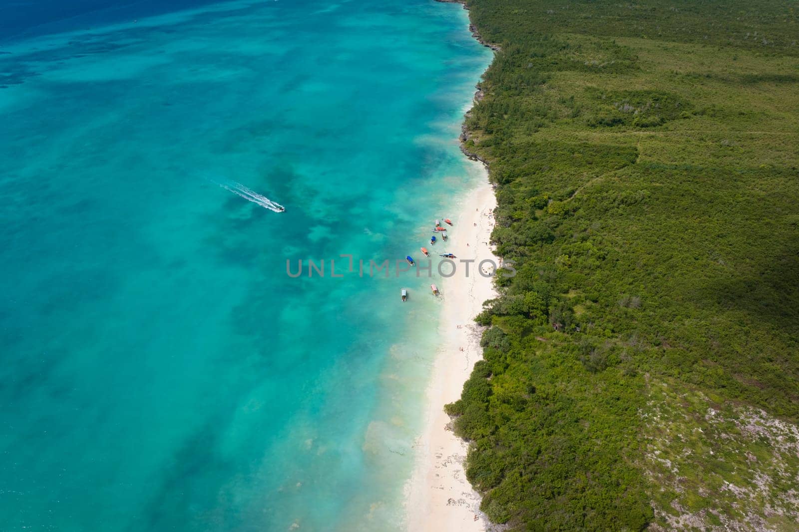 Aerial view of white sandy beach and turquoise ocean in zanzibar at sunny day by Robertobinetti70