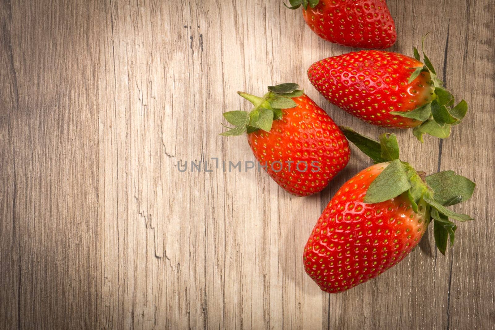Strawberries on wooden background with text clearance