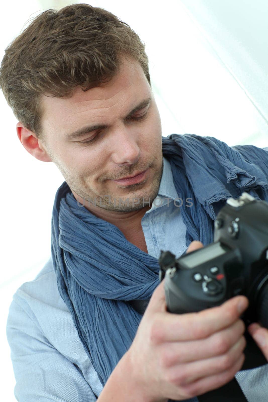 Handsome guy holding photo camera