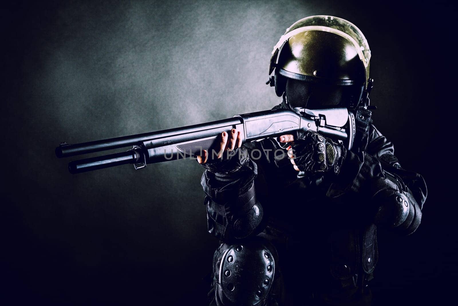Spec ops soldier on black background with shotgun
