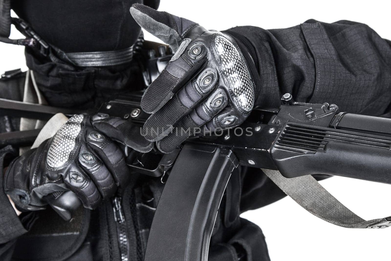 Spec ops soldier in black uniform and face mask with his rifle