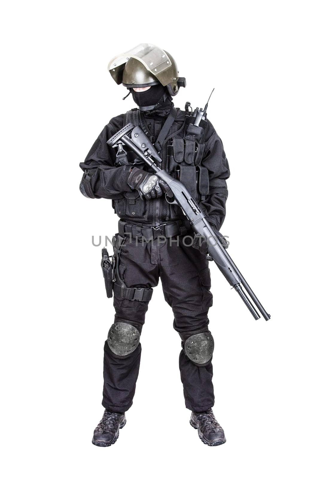 Spec ops soldier in black uniform and face mask with shotgun