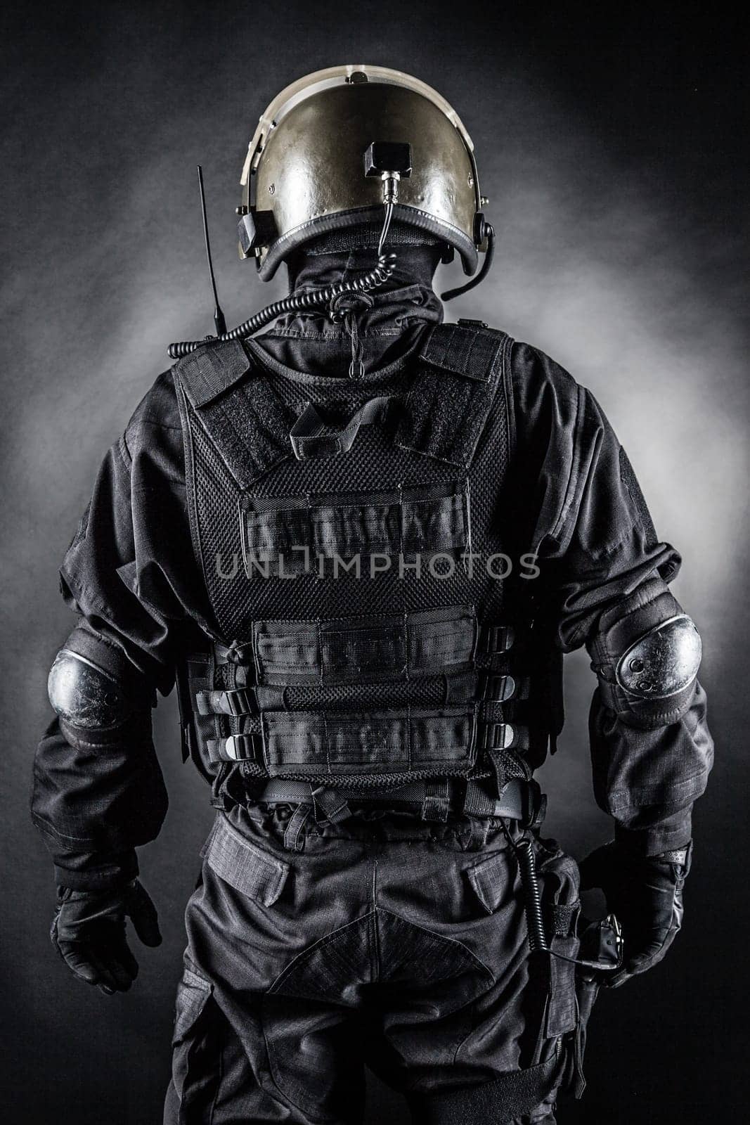 Spec ops soldier on black background shot from behind