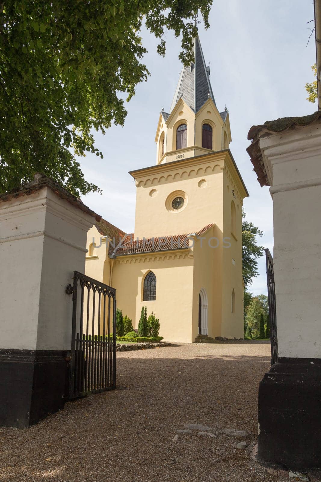 Church photographed through the entrance gate to the cemetery