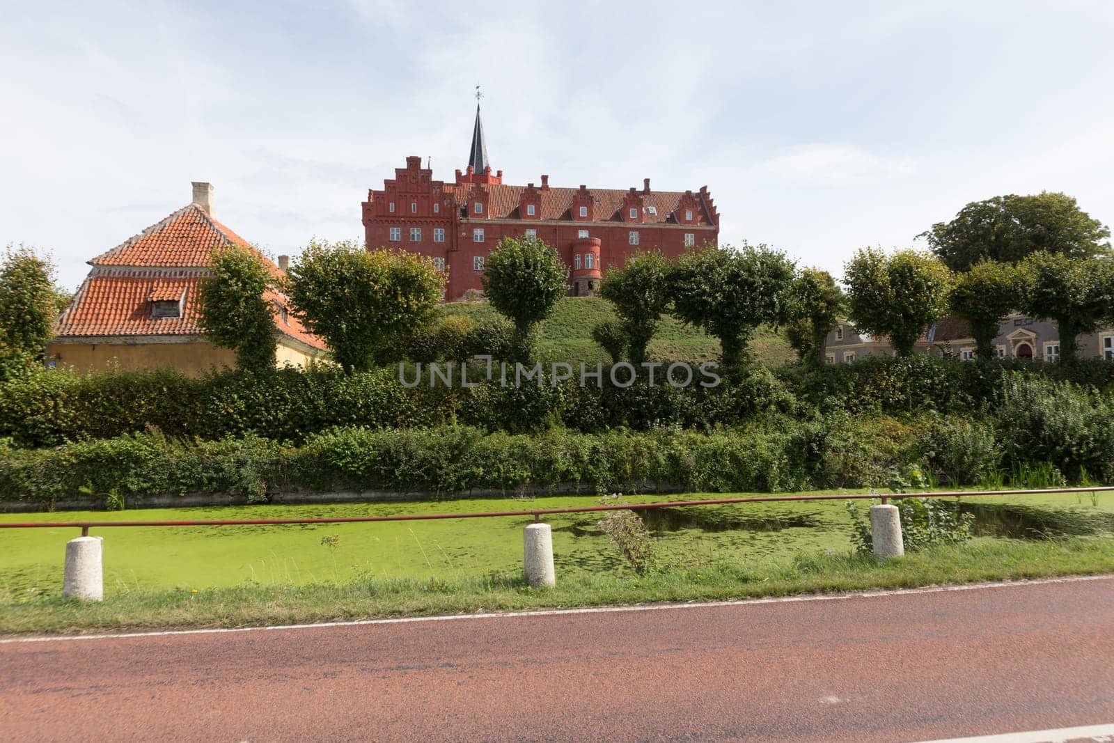 Castle of Tranekér behind trees and bushes