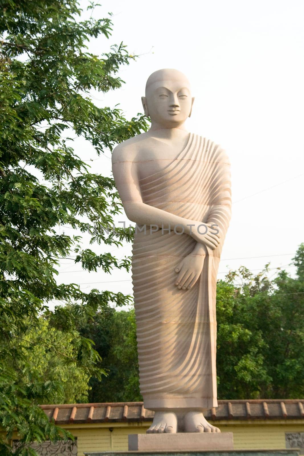 Statue of disciple of Buddha standing in tranquil mood, Bodhgaya, Bihar, India, Asia