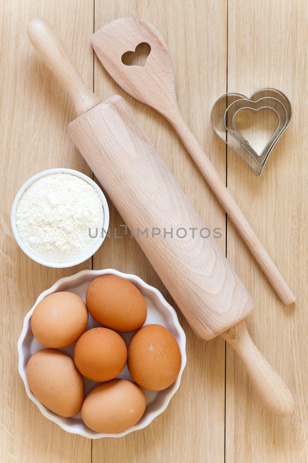 Baking ingredients and baking utensils on wooden substrates