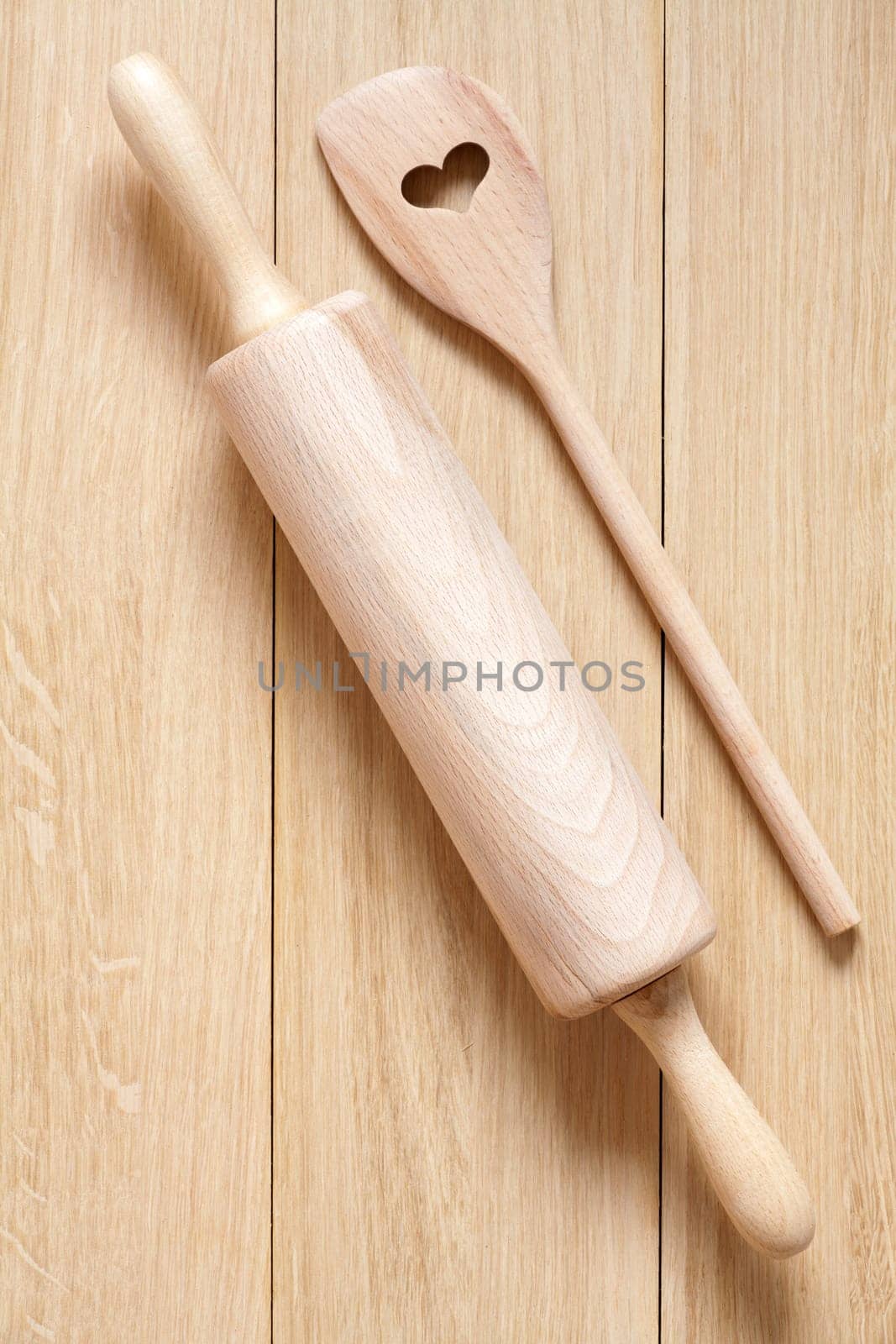 Dough roll and cooking spoon with heart cut-out made of wood